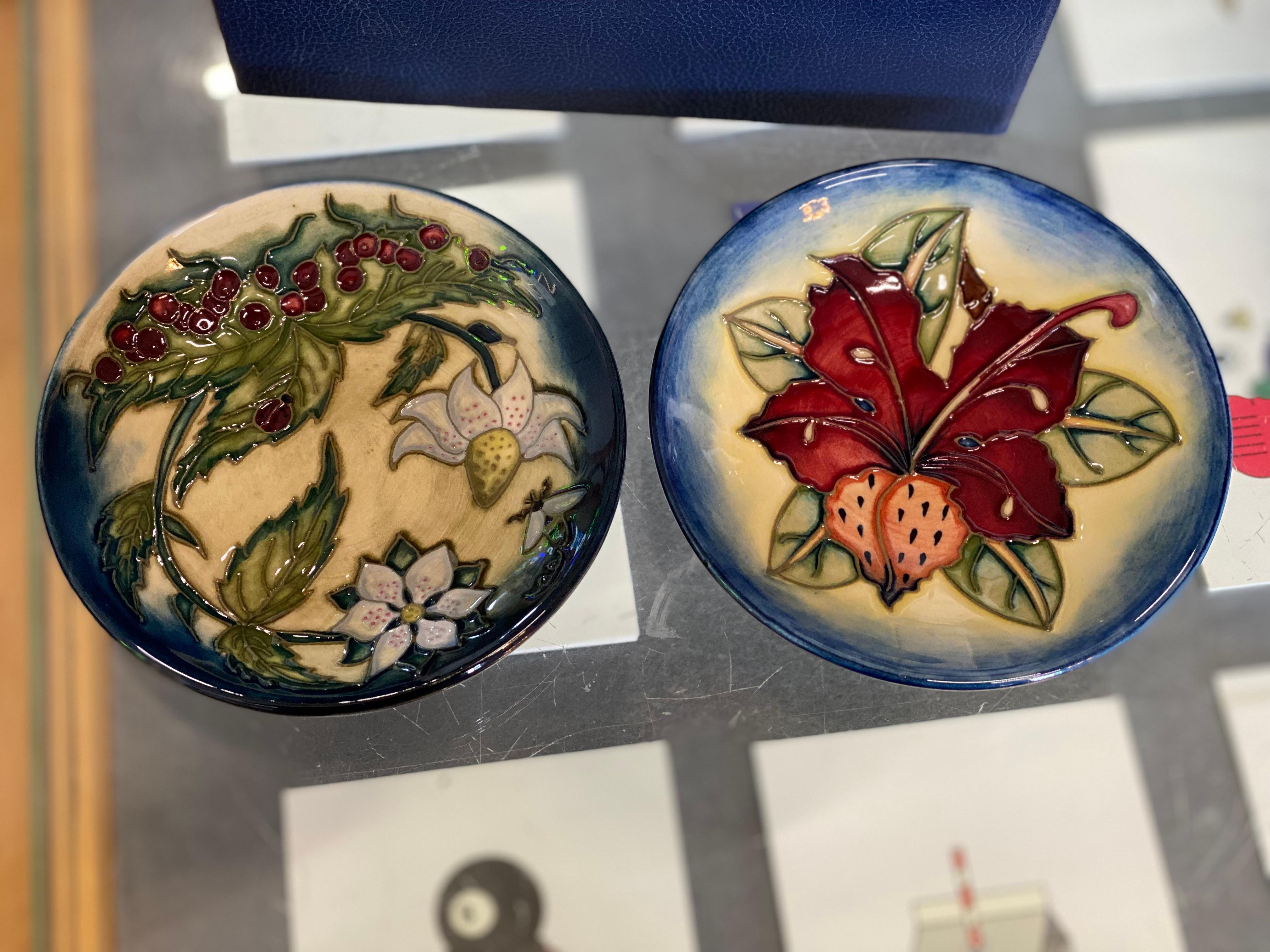2 Small Moorcroft ceramic plates, the so-called 780/4 trays. The ceramic plates have two different floral designs, are hand painted and glazed to a high gloss. Two great collector's items, delightful hall trays for personal treasures and a touch of