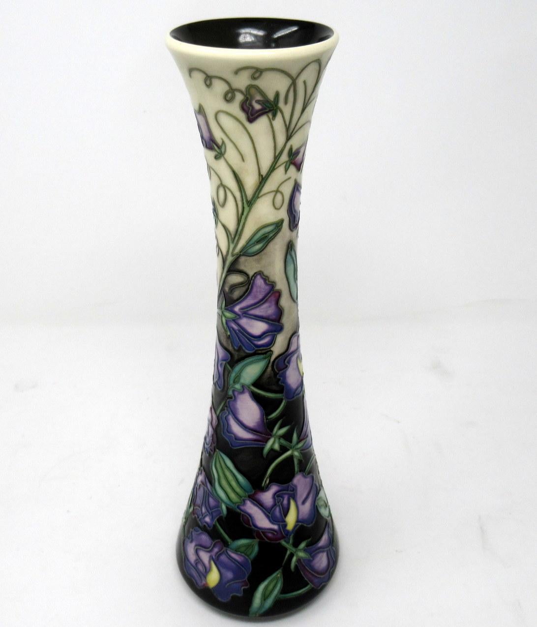 Superb Hand Painted Art Pottery Moorcroft Large Collectors Club Flower Vase of tall slender waisted outline and narrow circular opening. Made in Stoke-in-Trent, England. Decorated in the “Sweet Pea” Pattern by premier Moorcroft Artist Sally Tuffin.