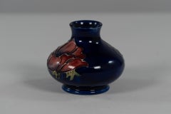 William Moorcroft. A small Anemone blue vase signed H M Made in England.