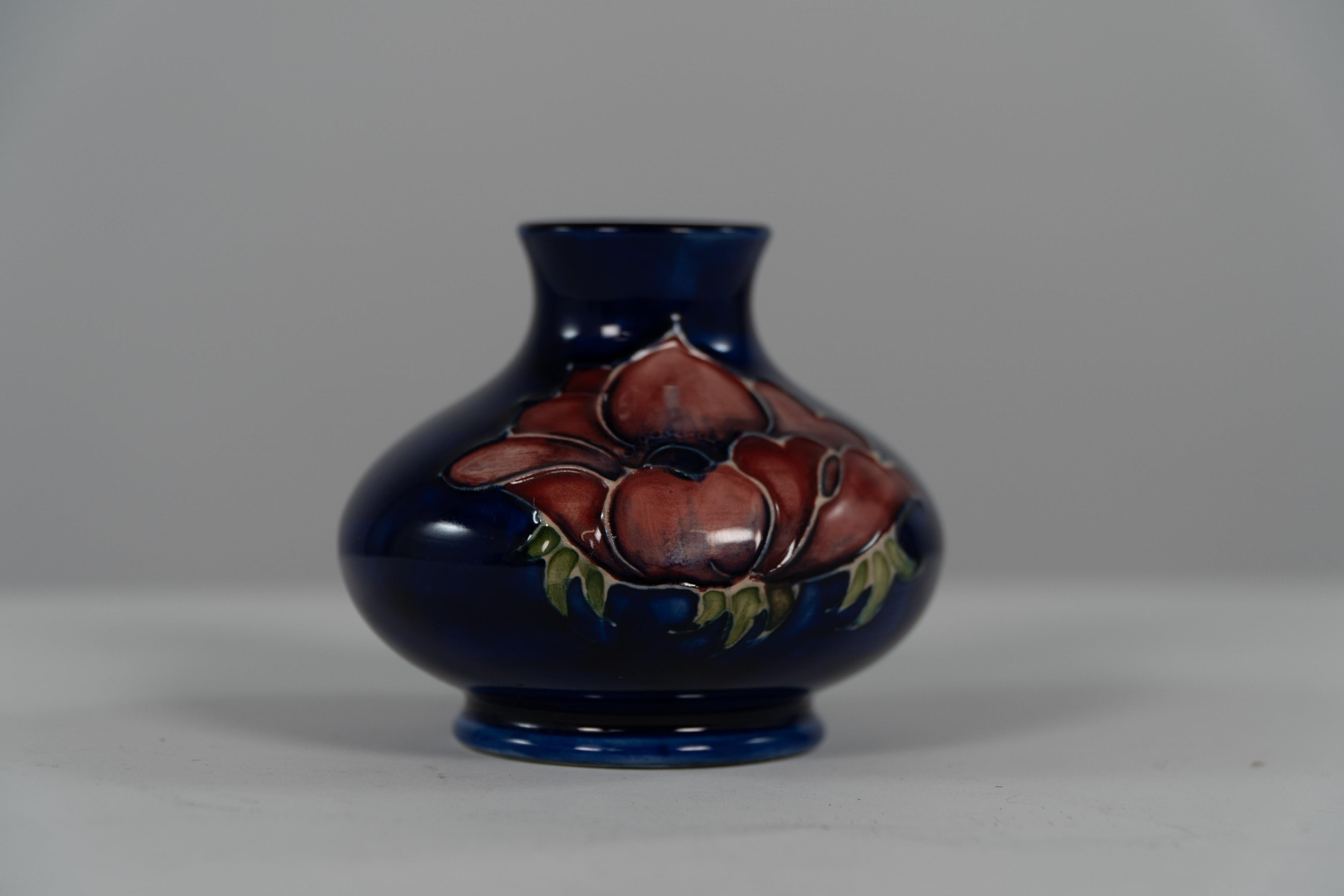 Arts and Crafts William Moorcroft. A small Anemone blue vase signed H M Made in England. For Sale