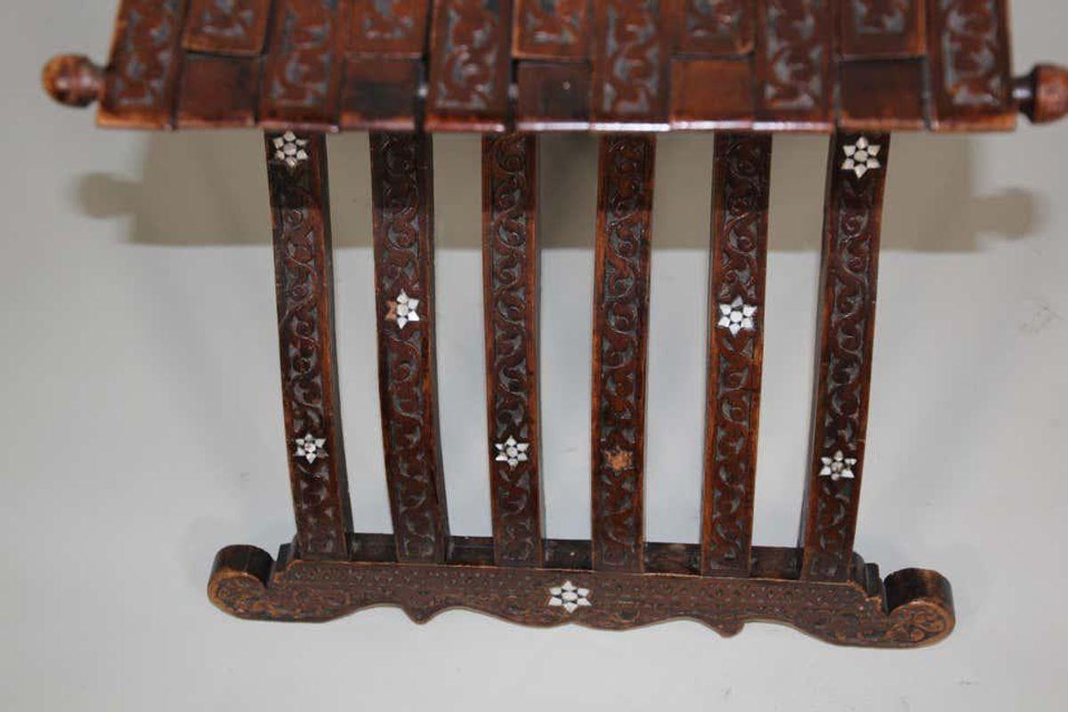 Antique Middle Eastern wood folding Moorish chair with intricate foliate carving inlays.
Inlaid and hand carved with Arabic design motif and foliages.
Some inlay missing, great antique patina
19th century Egyptian, Lebanese style chair circa