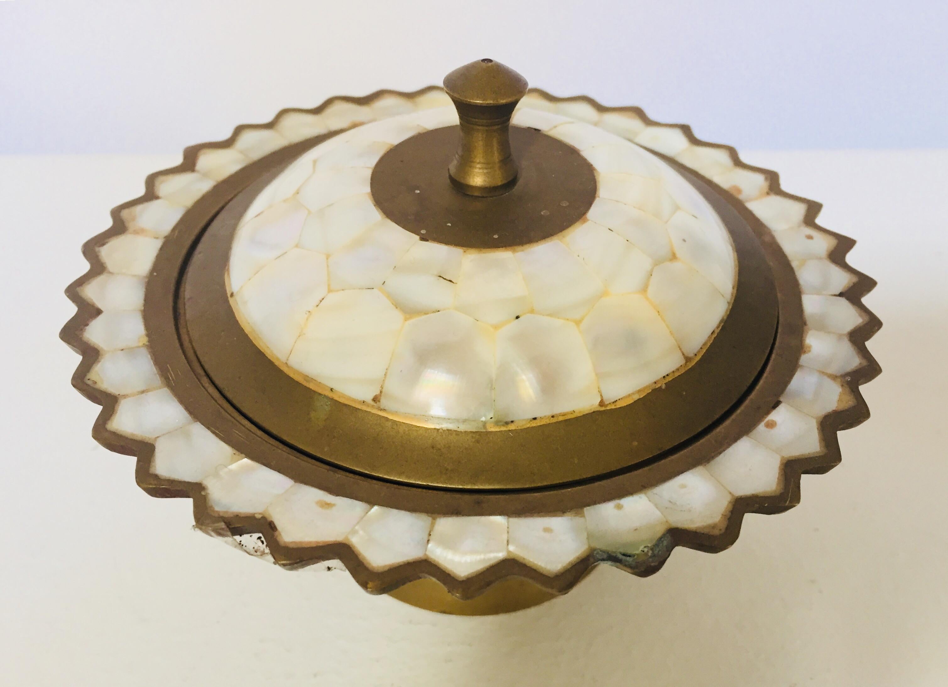 Moorish brass and mother-of-pearl container with lid.
Decorative sugar bowl, caviar bowl, made from brass with inlay mother of pearl tiles.
Islamic folk art.