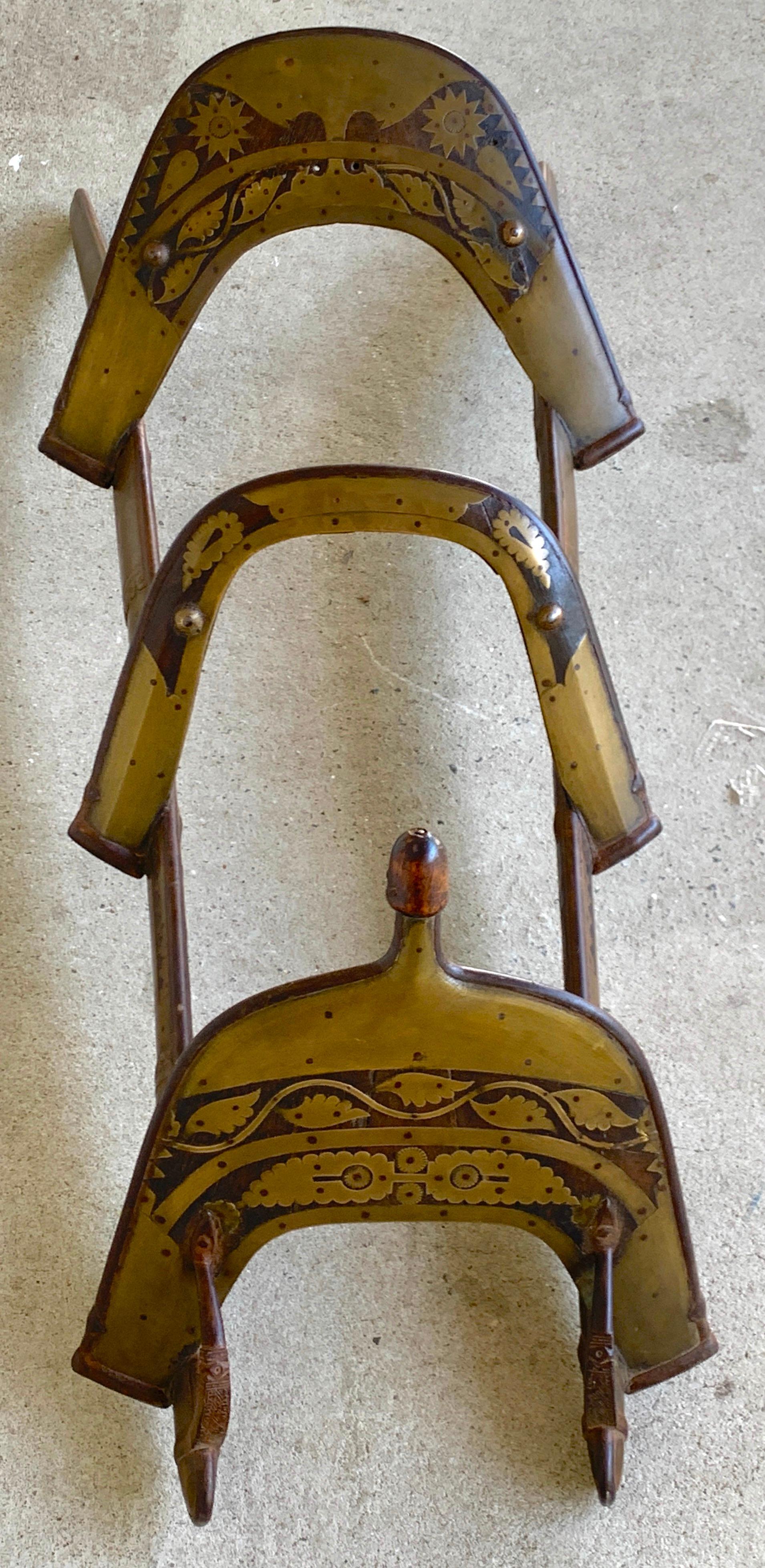 Moorish Brass inlaid camel saddle /towel rack 
The finest example, heavily inlaid with brass, possibly originally an officers or wealthy persons saddle. 
Can be easily mounted and used as a towel or clothing rack.
 
