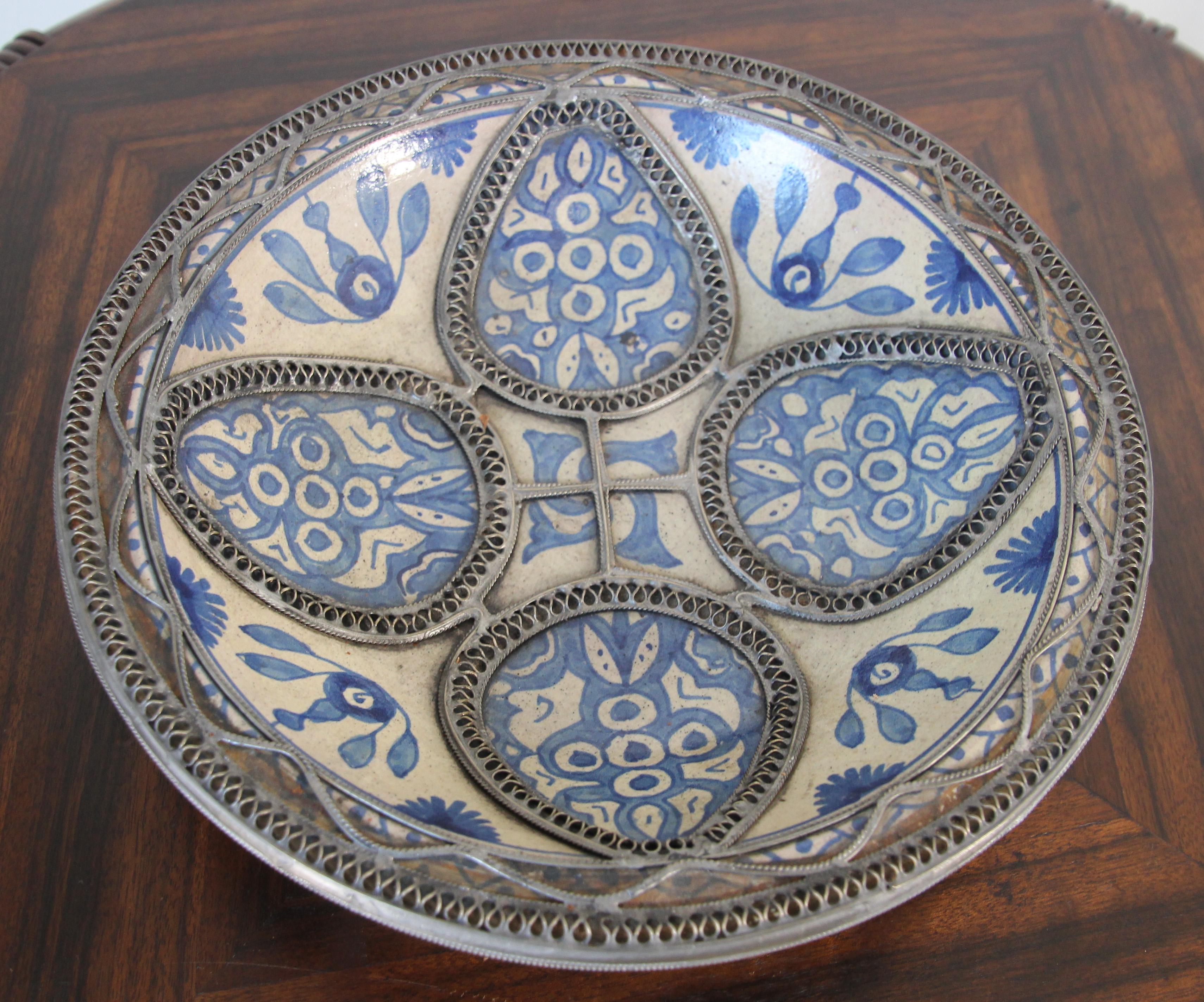 Handcrafted Moorish Moroccan blue decorative ceramic Bowl, dish from Fez.
Moroccan ceramic bowl in Bleu de Fez, very nice designs hand painted by artist in Fez.
Geometrical and floral Moorish designs and adorned with nickel silver filigree
