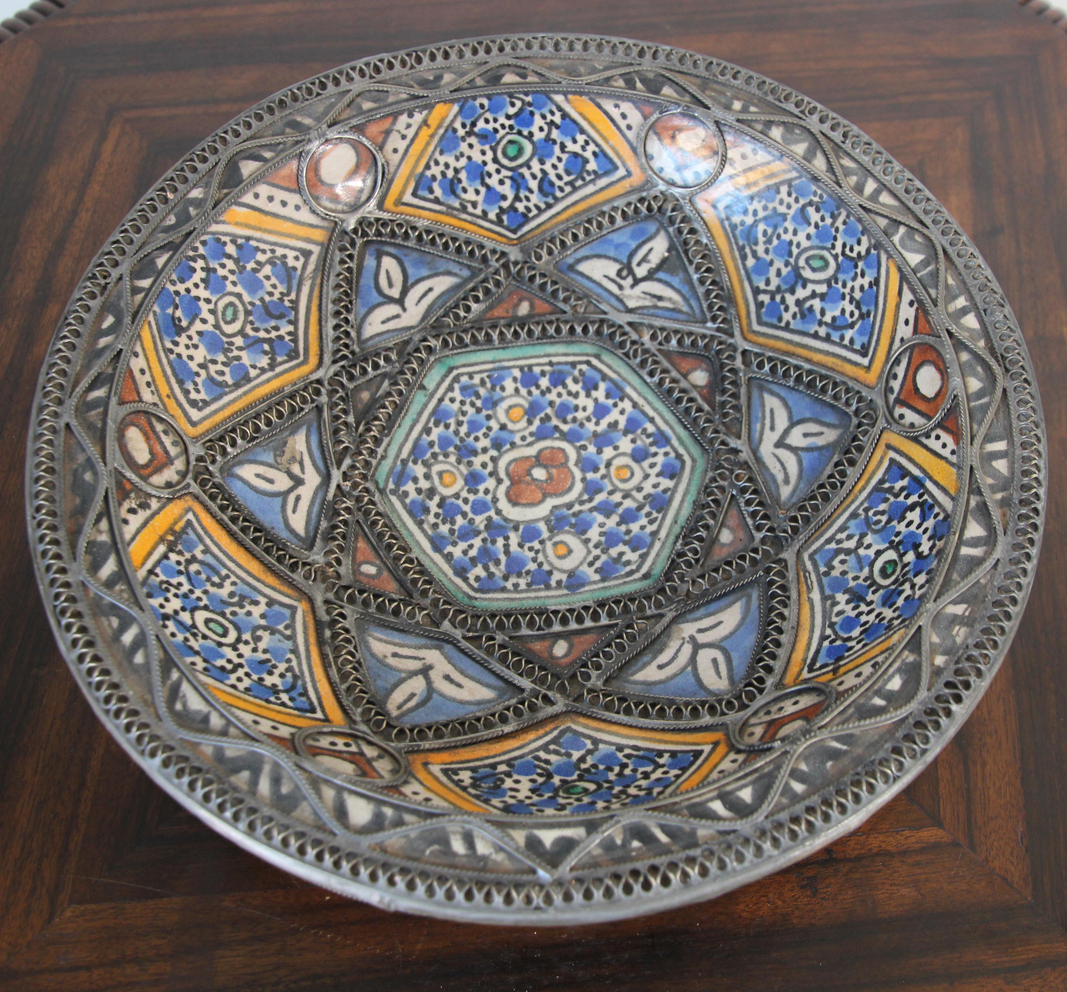 Handcrafted Moroccan polychrome decorative ceramic Bowl, Moorish dish from Fez.
Moroccan ceramic bowl in Bleu de Fez, very nice designs hand painted by artist in Fez.
Geometrical and floral Moorish designs and adorned with nickel silver filigree