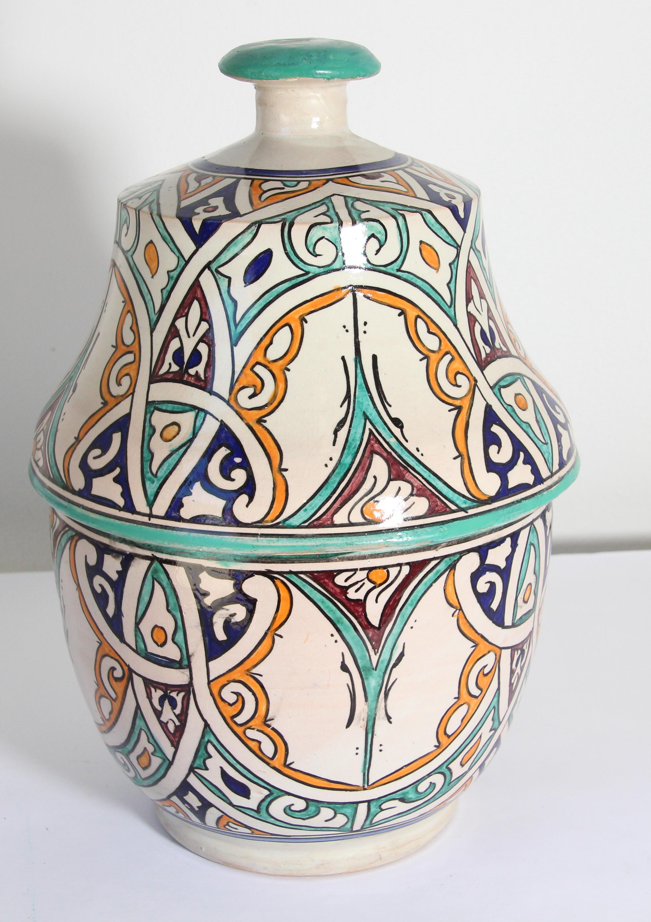 Moroccan glazed polychrome ceramic jar tureen with cover.
Hand painted ceramic Jubbana, handcrafted by skilled Moroccan artisans in Fez Morocco.
Moorish designs in turquoise, cobalt blue, teal, saffron yellow, prune and ivory colors.
Size: 14