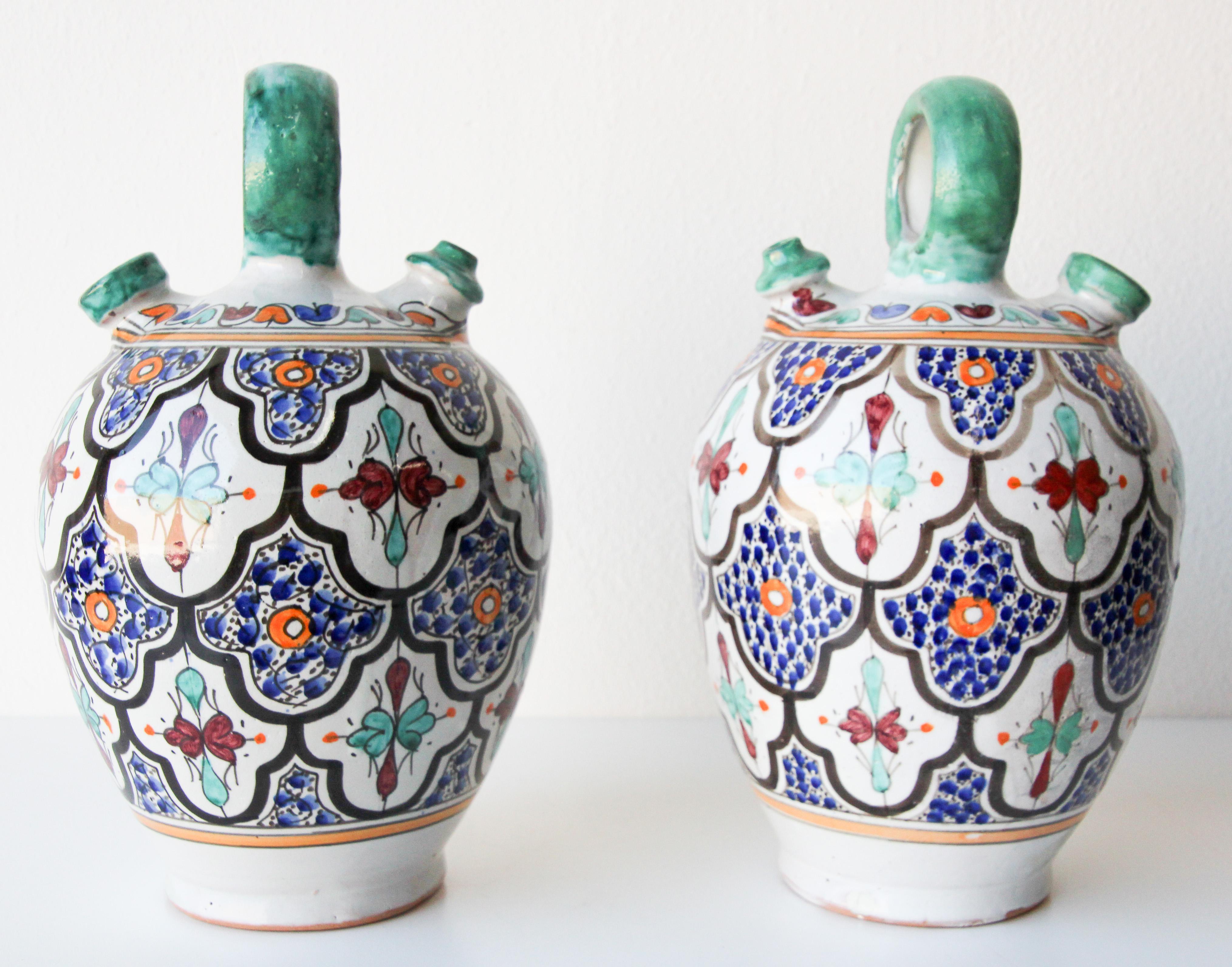 Large pair of Moroccan glazed polychrome ceramic water jug with handle.
Hand painted ceramic handcrafted by skilled Moroccan artisans in Fez Morocco.
Moorish designs in turquoise, cobalt blue, teal, saffron yellow, prune and ivory colors.
Size: