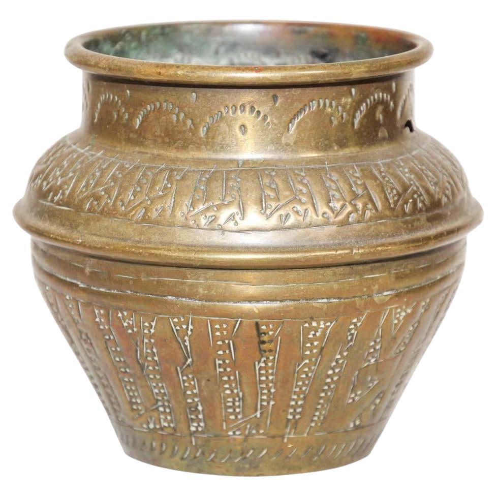 Small brass Middle Eastern Moorish bowl finely and heavily hand-etched and hand carved with brass repousse and decorated with Arabic inscriptions. 
19th Century Islamic Moorish hand-etched Mameluke style brass bowl. Could be used as a jardinière
