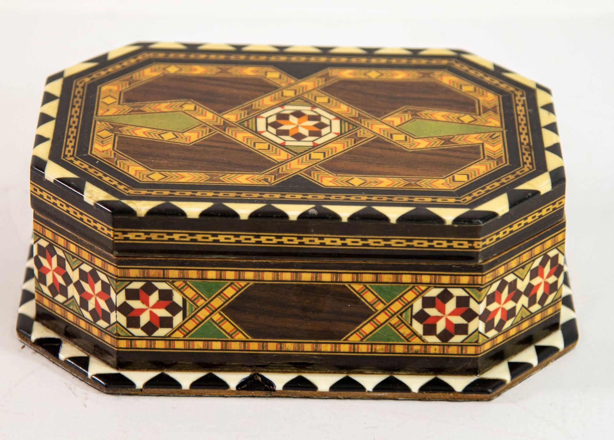 Inlaid Marquetry Moorish Jewelry octagonal Box hand-crafted in Spain.
Hispano Mauresque exquisite handcrafted vintage Middle Eastern style mosaic marquetry inlaid walnut wood box.
Handcrafted in Spain in the Moorish Syrian style with red velvet