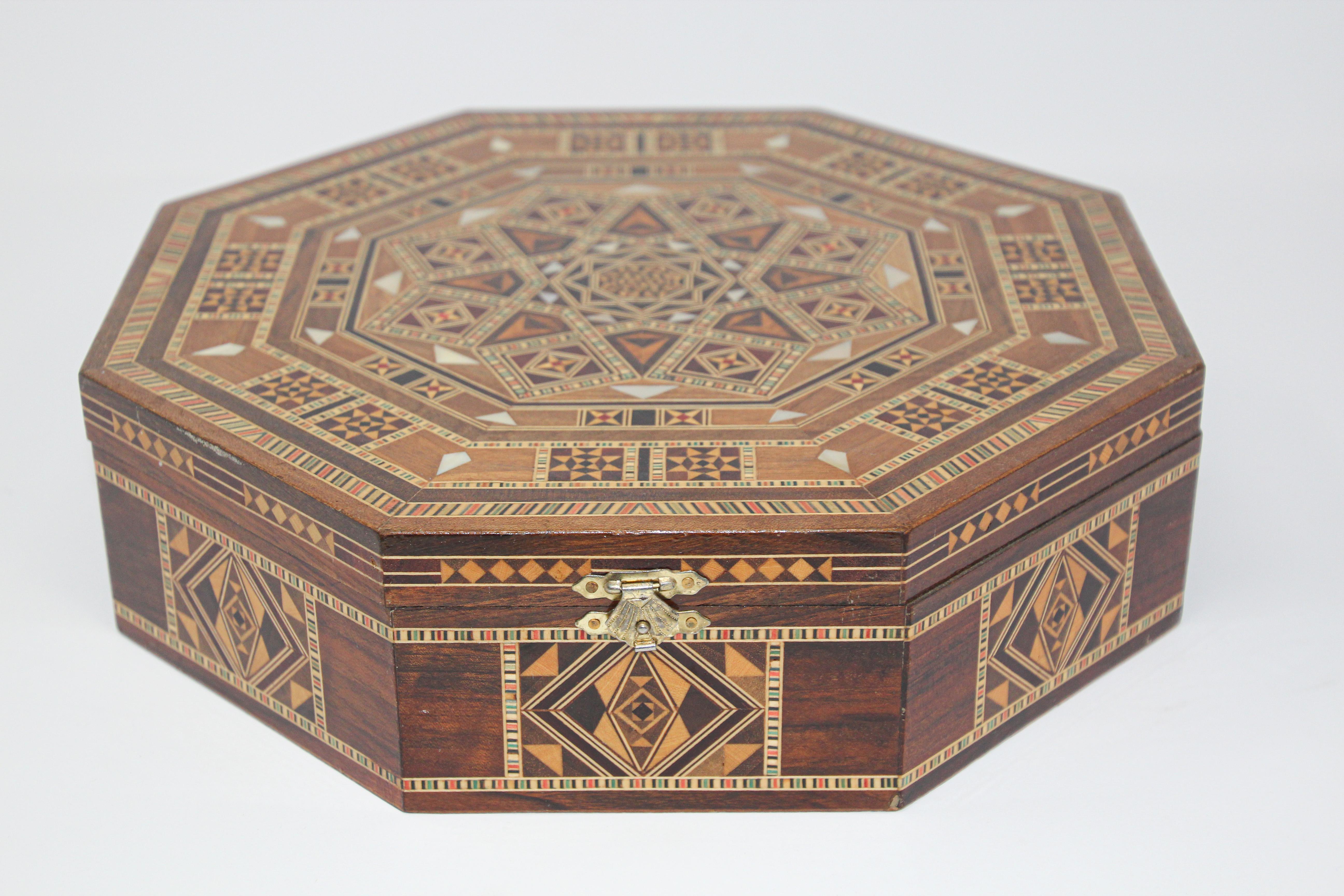 Large Moorish inlaid marquetry mosaic octagonal jewelry box.
The amazing craftsmanship in intricate marquetry fruitwood with mosaic Moorish geometric pattern and mother of pearl inlay makes it a true work of art. 
Handcrafted this decorative