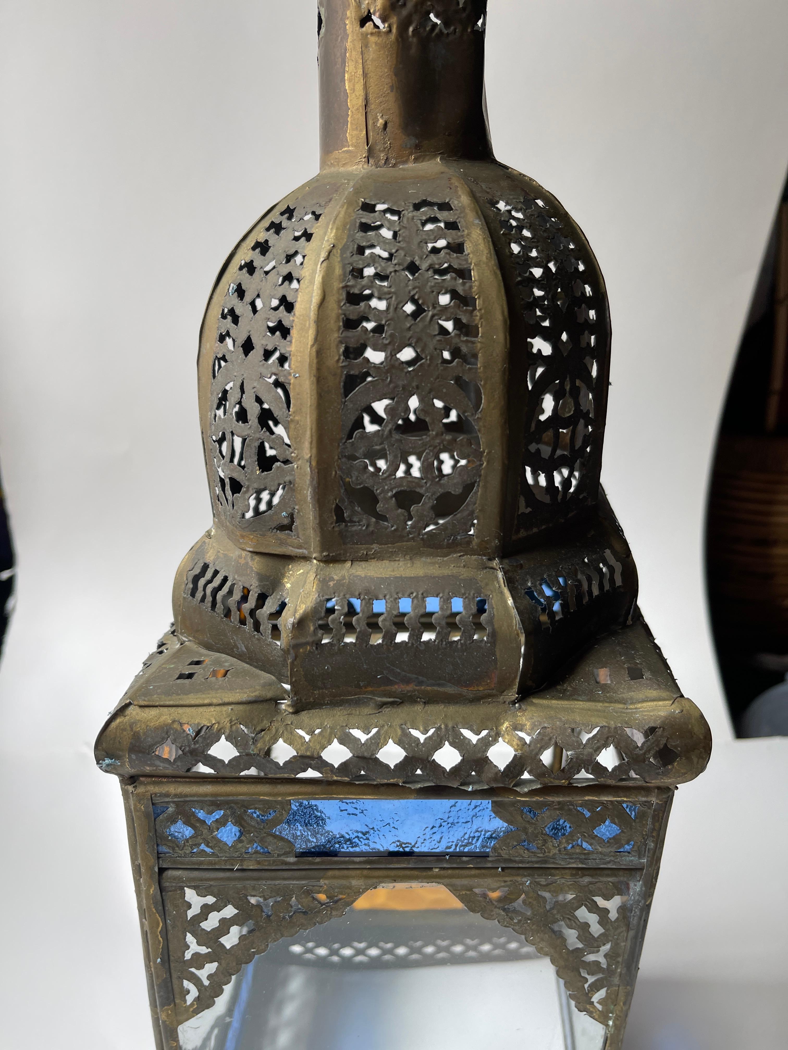 Moorish perforated tin dome lantern has clear, blue and amber glass panels for more illumination. Hangs with ring shape hanger at top.
May be used as a light catcher and an accessory to Moorish and Mexican decor, as it is currently not wired