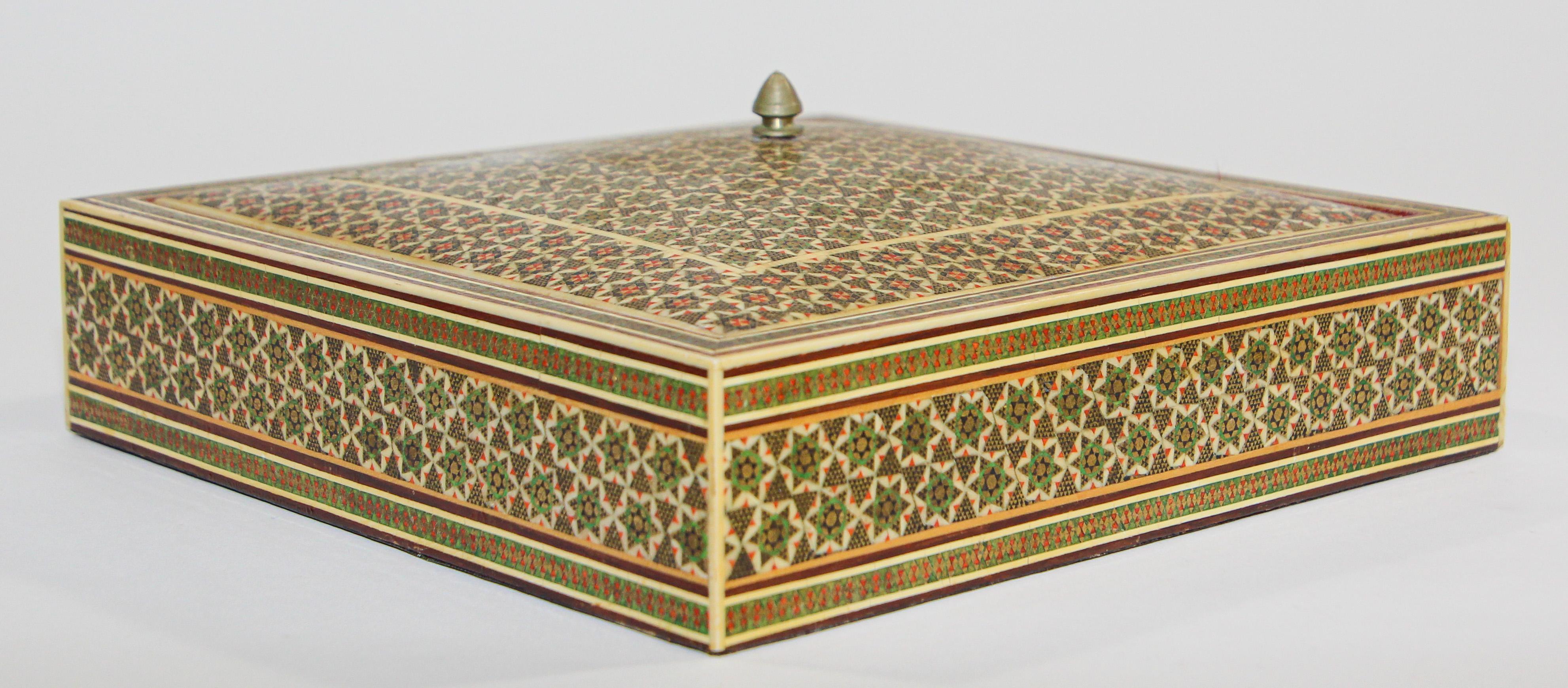 Moorish style micro mosaic marquetry inlaid jewelry box with lid.
Intricate inlaid Anglo Indian box with floral and geometric Islamic 
Moorish mosaic Sadeli design in a square shape form with mosaic inlay and marquetry, very fine artwork, lined in
