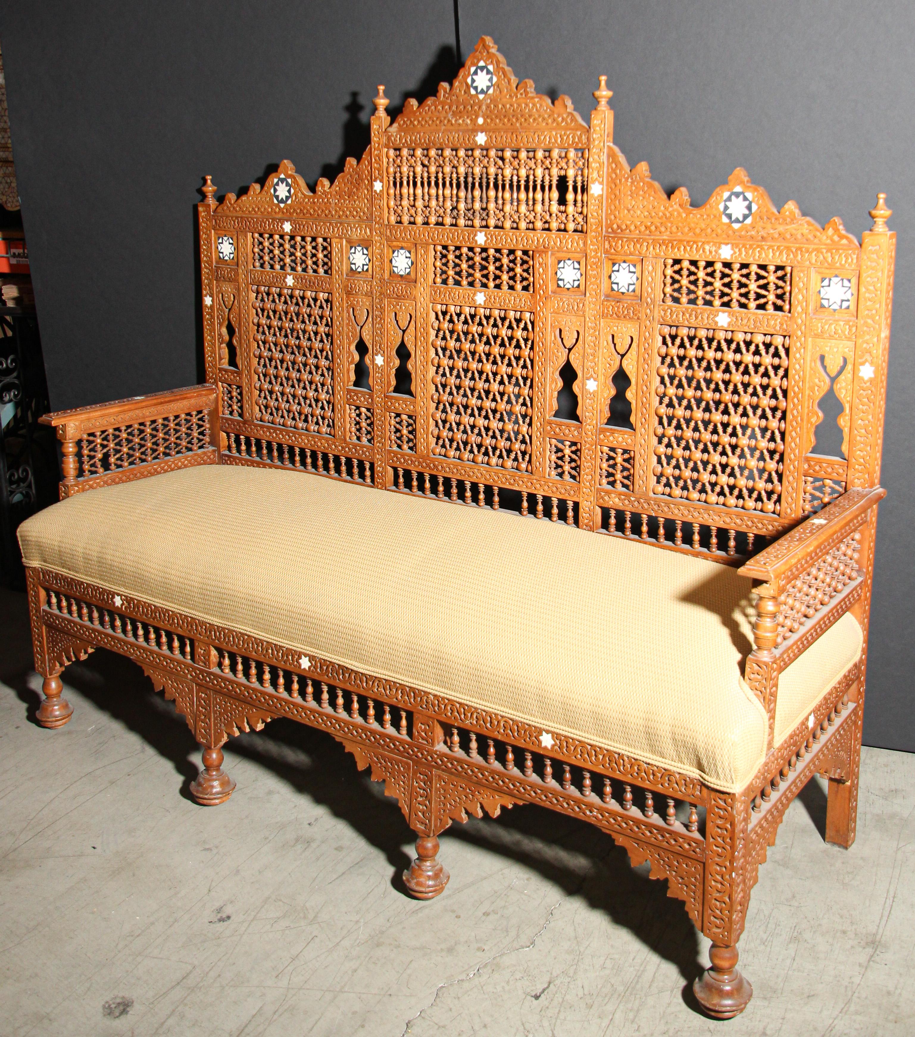 Fabulous one of a kind Moorish Middle Eastern, handcrafted Settee, finely hand-carved and inlaid.
Nice Egyptian musharabie fretwork designs all-over the chair.
Newly upholstered with gold Moroccan fabric. 
Very fine Moorish