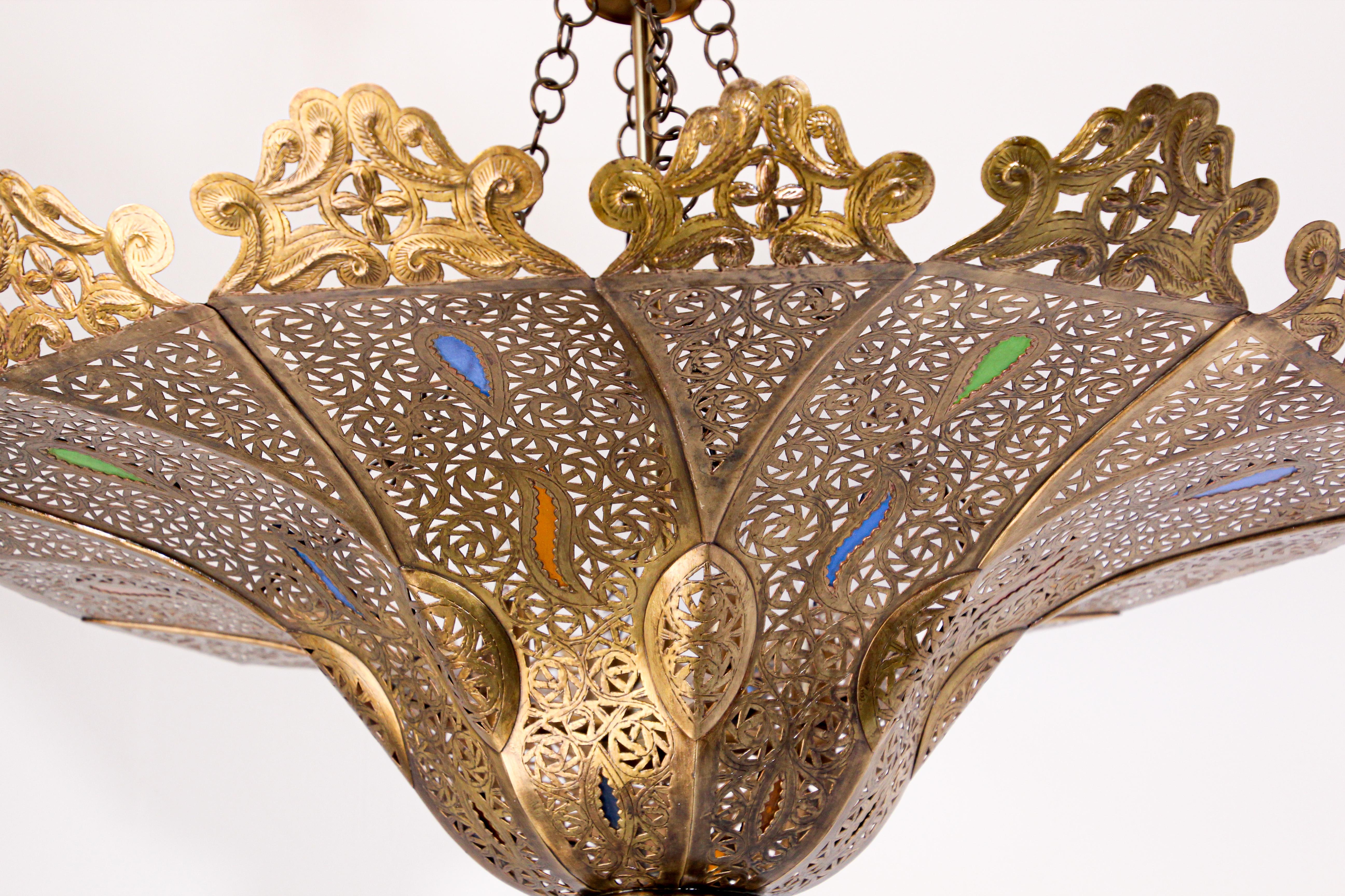 Moroccan Moorish brass chandelier in Alberto Pinto style.
The Pasha Moroccan chandelier is finely handcrafted and chiseled with Moorish motifs.
Handmade of brass with some hand blown decorative colored glass in cobalt blue, emerald green and