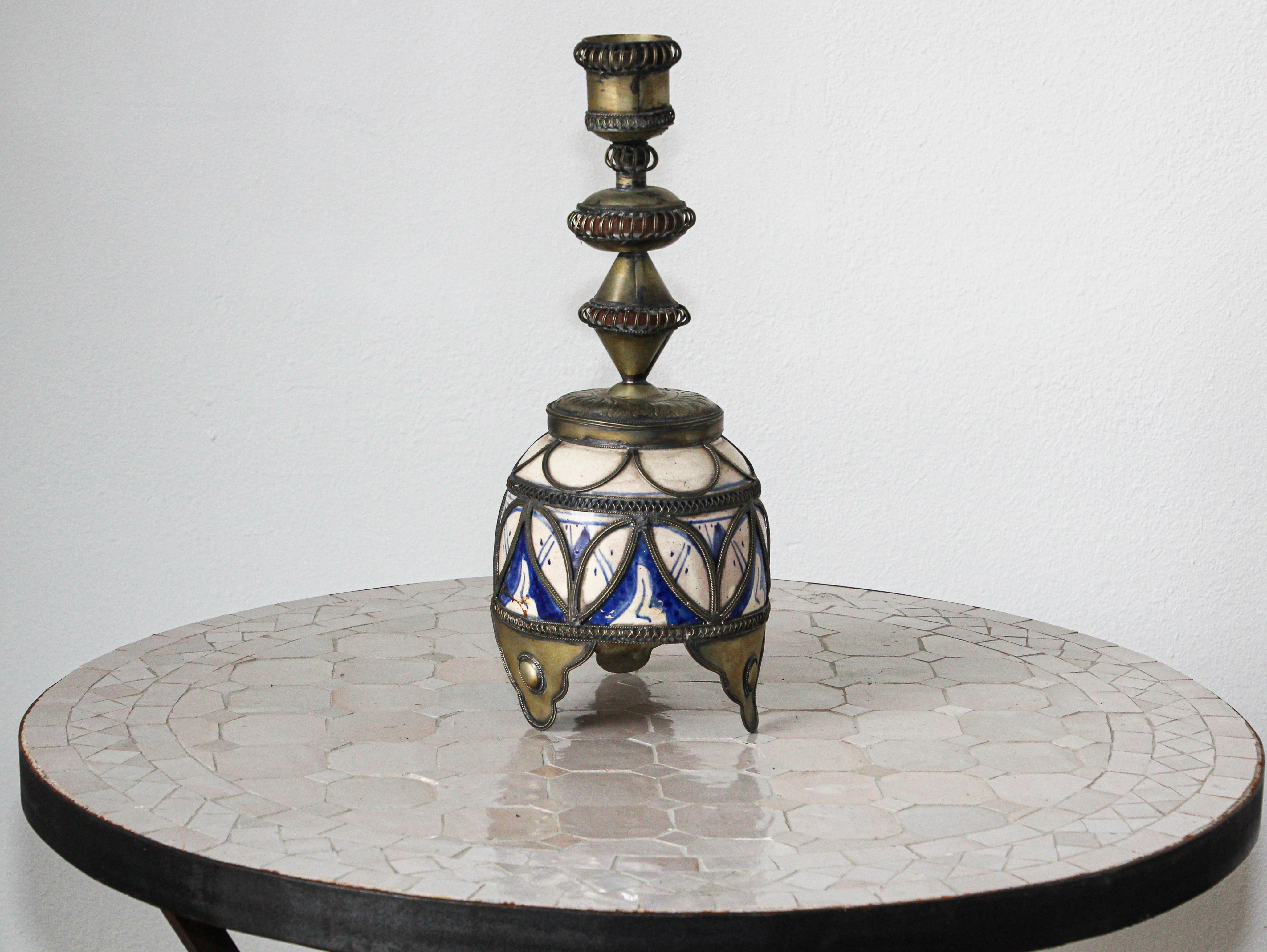 Fabulous handcrafted antique Moroccan blue and white footed ceramic candle holder in Moorish style.
 Adorned with fine filigree silver nickel work.
Candlestick with white and blue color of the ceramic is renowned as bleu de Fez.
Handcrafted in