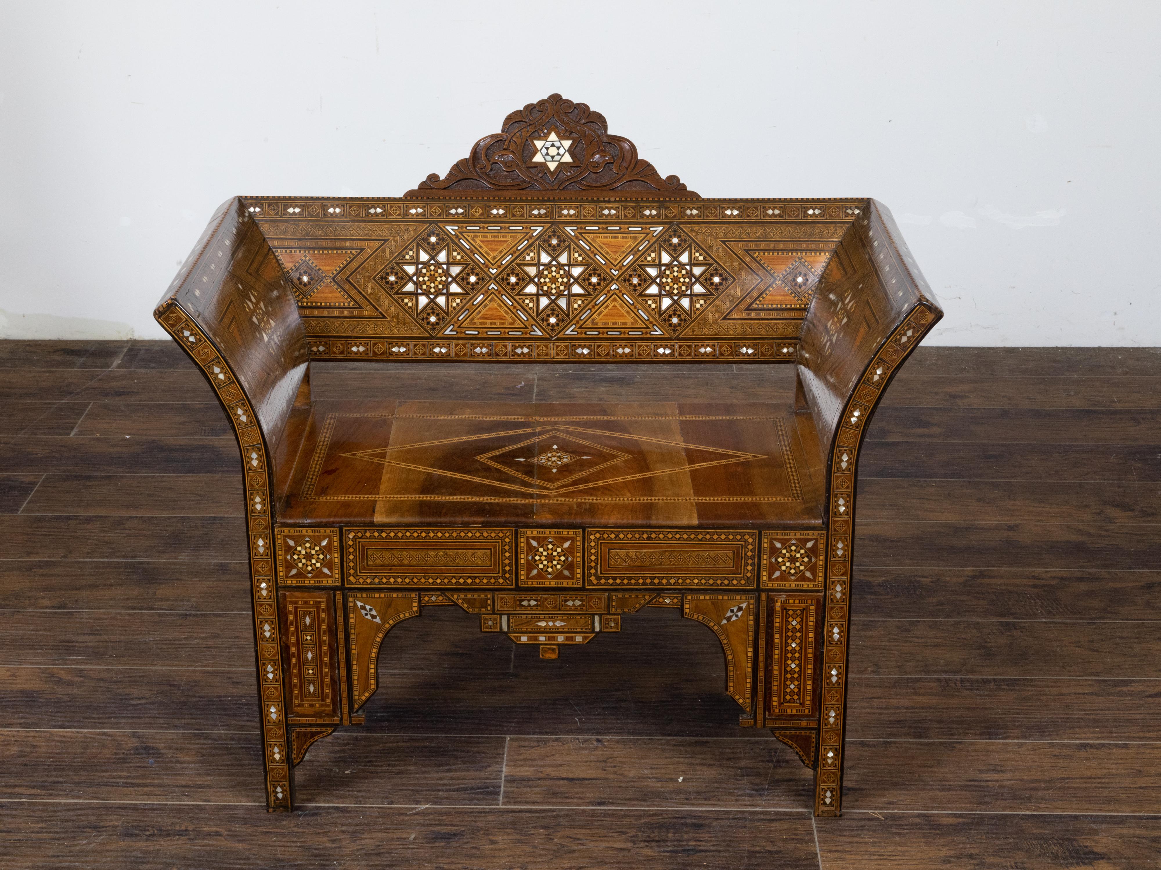 This Moorish style Moroccan armchair, dating back to circa 1900, will instantly enchant the viewer with its out-curving back and arms, intricate geometric inlay, mother of pearl motifs, and gracefully carved legs. The armchair embodies the essence