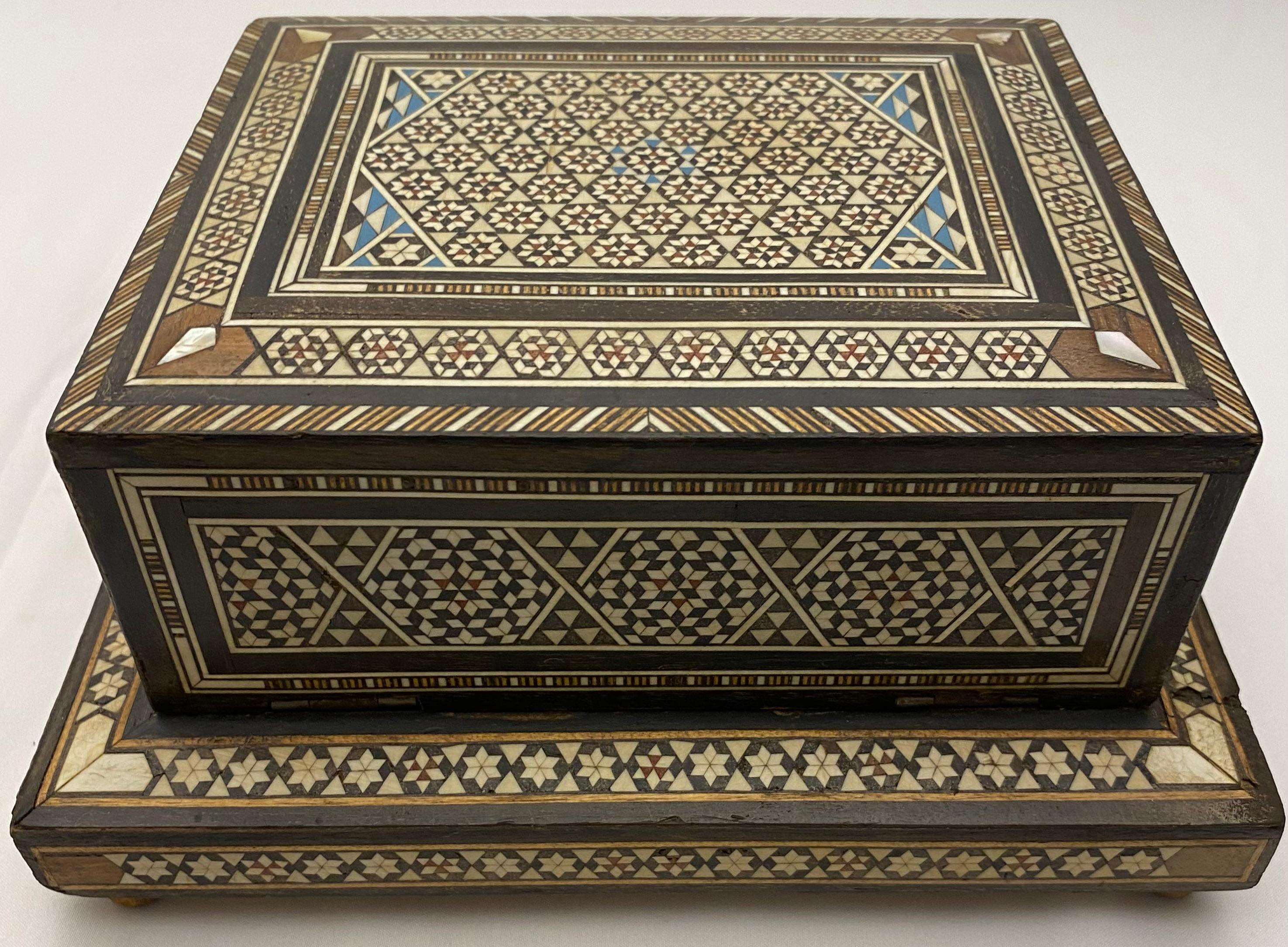 Vintage Moorish style cigarette music box inlaid with mother of pearl and ebony. Handcrafted using very fine Moorish micro mosaic inlaid geometric marquetry artwork.

This box was traditionally used to store cigarettes and play music when you open