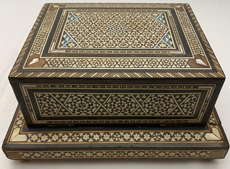 Vintage Moorish style cigarette music box inlaid with mother of pearl and ebony. Handcrafted using very fine Moorish micro mosaic inlaid geometric marquetry artwork.

This box was traditionally used to store cigarettes and play music when you open