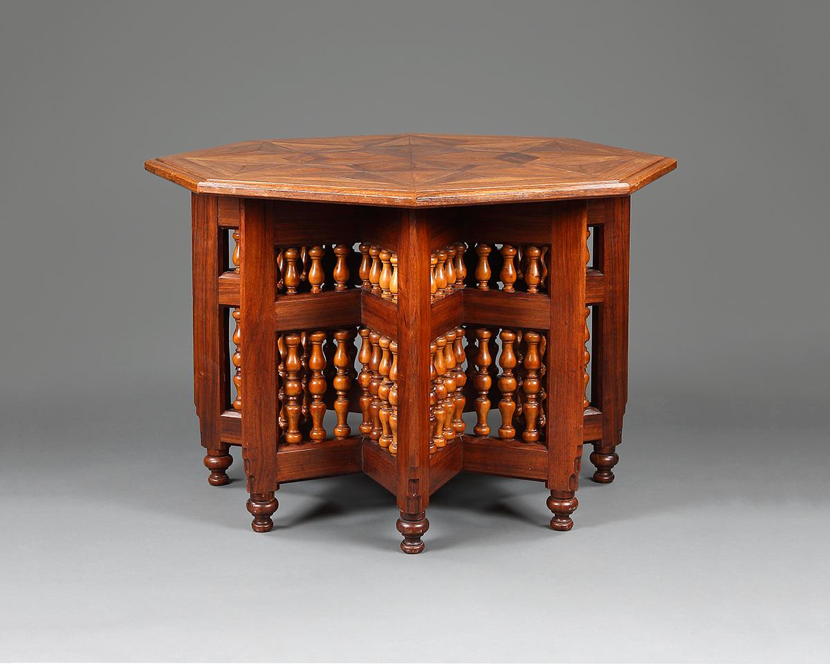 An Anglo-Indian Moorish style mahogany octagonal table with fine parquetry top and baluster-turned panels forming the legs with baluster feet, probably of colonial manufacture.

Probably Bombay, circa 1900.