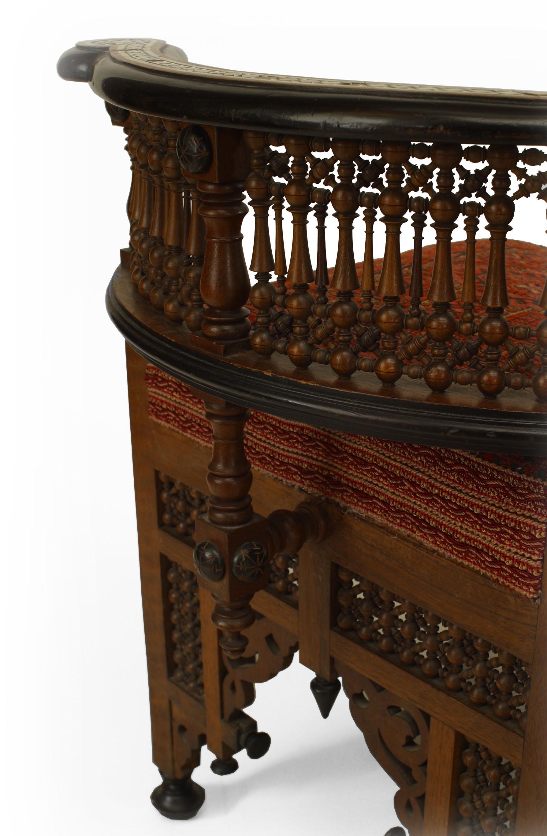 Middle Eastern Moorish style (19th Cent) walnut carved tete-a-tete with ebonized trim and inlaid with mother of pearl and 2 seats upholstered with Persian rug fragments.
   