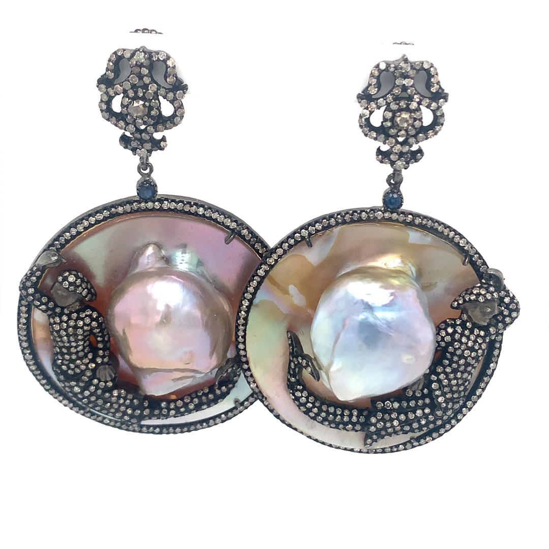 Beautiful natural pair of 125-Carat Mother of Pearl, 0.20-Carat Sapphire and 3.60-Carat Diamond earrings set in sterling silver. 