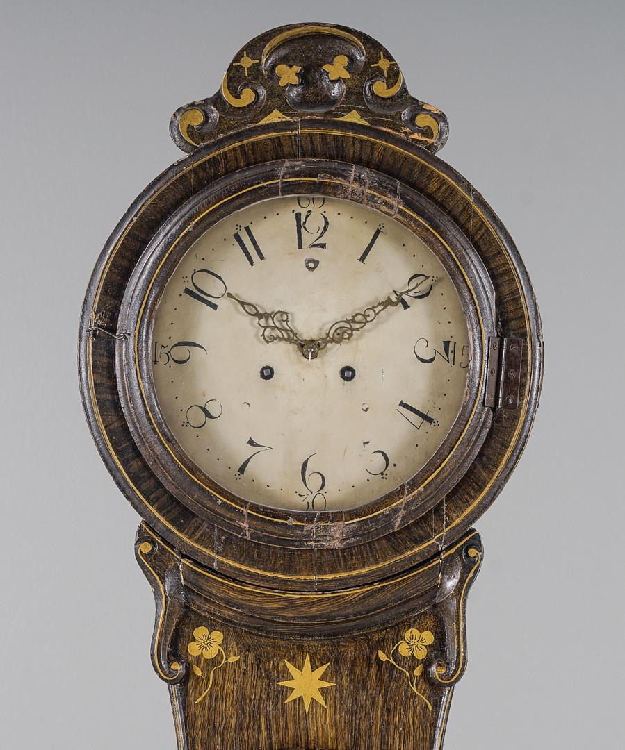 Antiguo reloj de mora sueco de la década de 1800 con un raro acabado de arte popular de imitación de grano de madera y una esfera de números romanos magníficamente detallada y en buen estado. Medidas: 217 cm.

Es probable que el reloj sea de