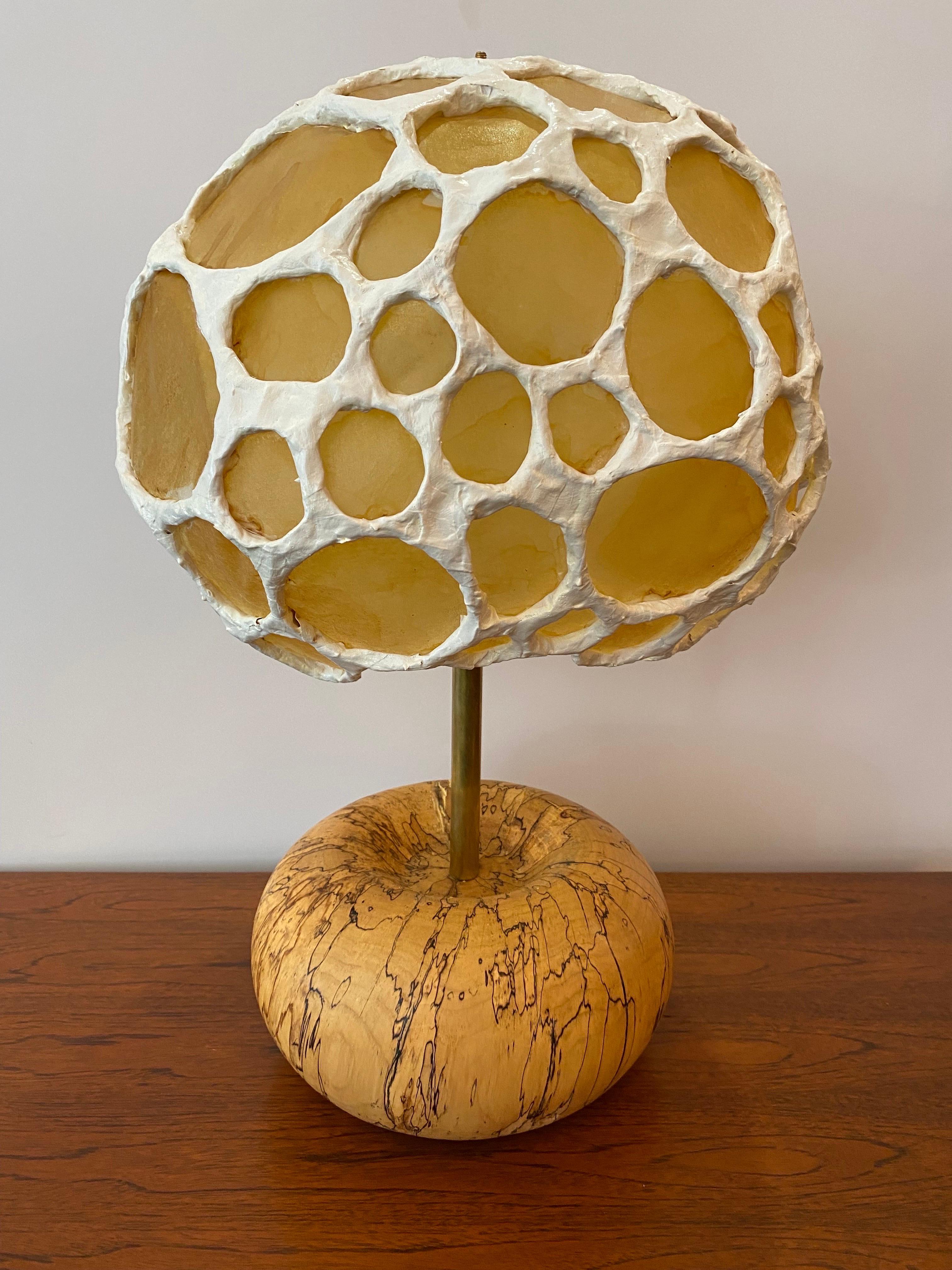 The base of this Morchella lamp is made from turned end-grain spalted maple. Spalting occurs when fungi invade and digest wood. The line patterns that form are called zone lines. These zone lines are barriers that fungal agents produce in order to