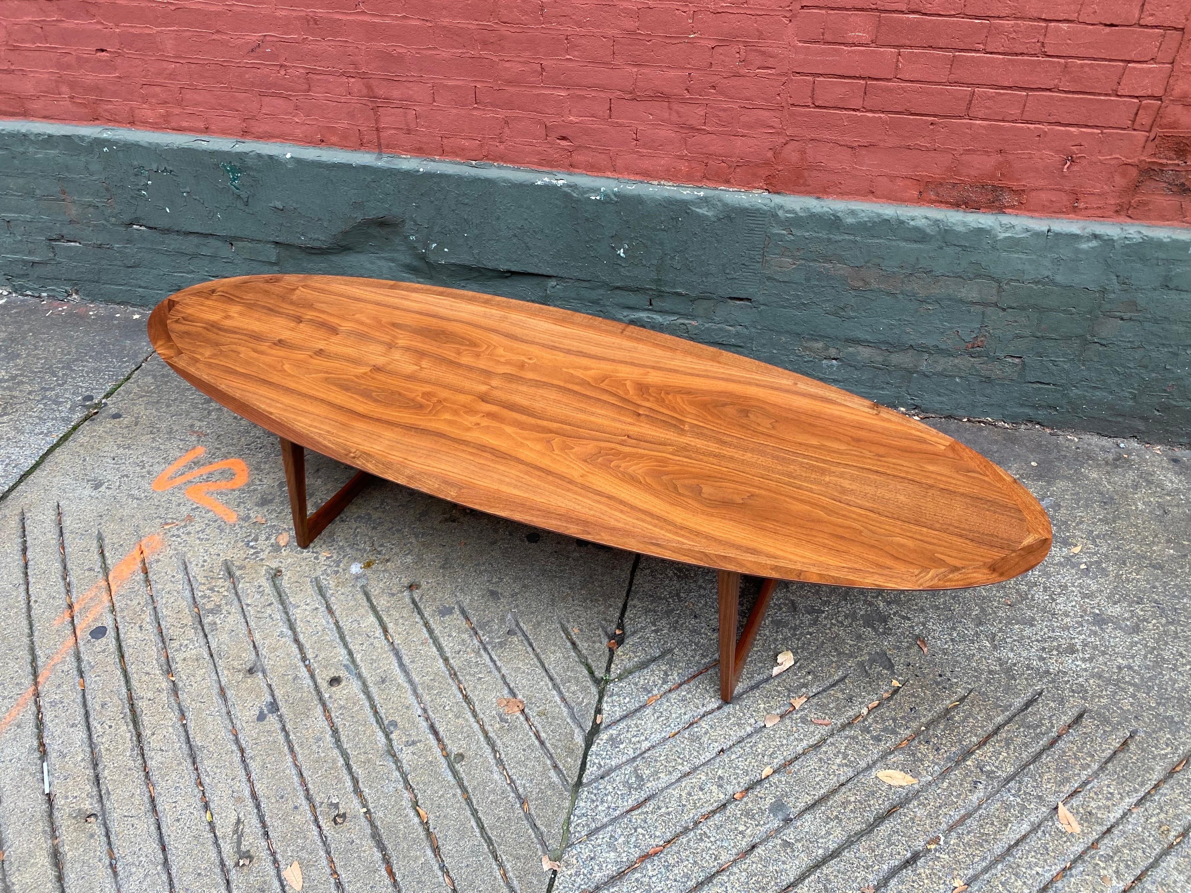 Moreddi Teak Surfboard Coffee Table with splayed legs.  Great scale and size!  Legs have a great angle that sets the table apart from the average!  Legs come off for easy moving and shipping.  Newly refinishe!