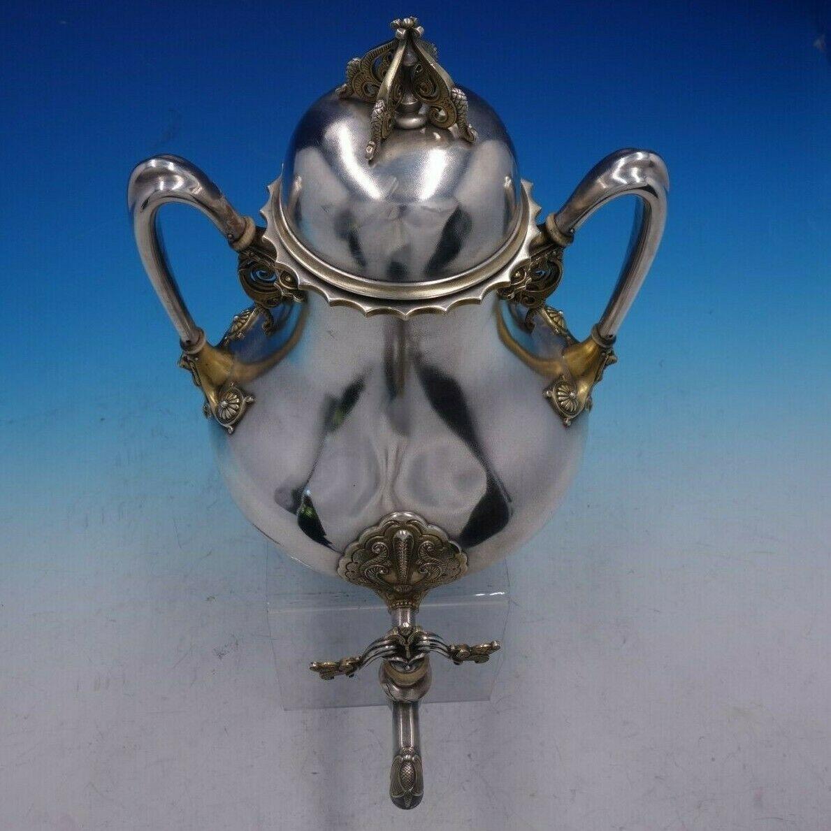 Tiffany & Co.

Superb Moresque by Tiffany & Co. sterling silver coffee kettle or urn from 1848-1873 with gold highlights and elaborate openwork handles, pattern 1770. Gorgeous original satin finish, with no stand.

It measures 11 1/2