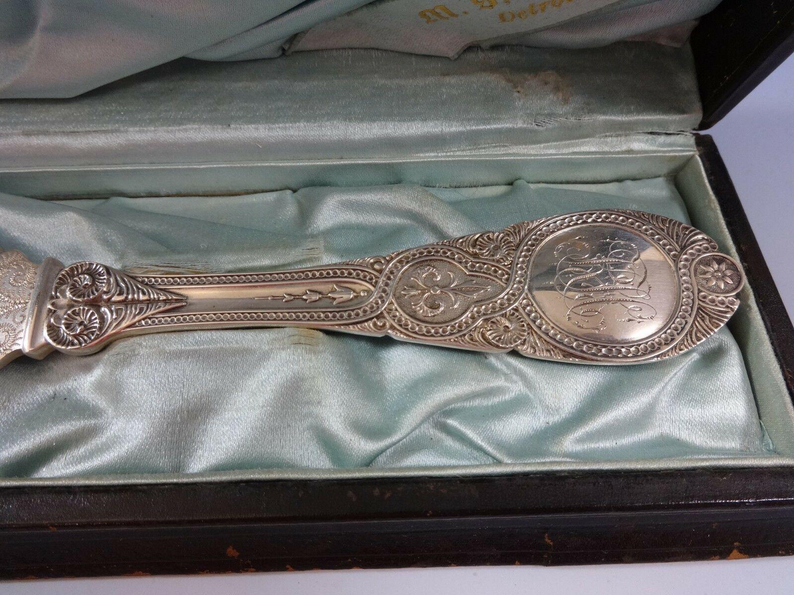 Moresque by Wendt

Moresque by Wendt serrated cake knife in original fitted box, all-sterling, 12”, monogrammed, circa 1873. Bright-cut leaves, bamboo, and bird on blade. Large, heavy, and impressive. Interior of box, excellent. Exterior of box,