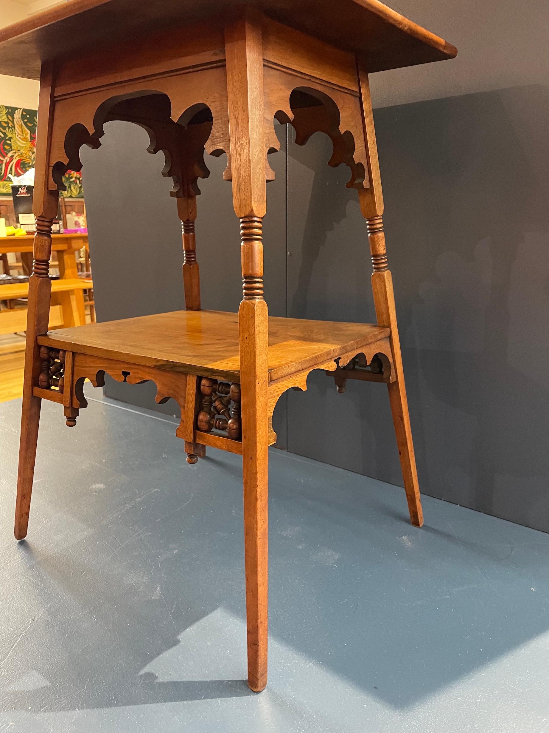 Moresque 2 tier side table in walnut

With mashrabiya panelling and decorative frieze

Circa 1885 

Liberty & Co 