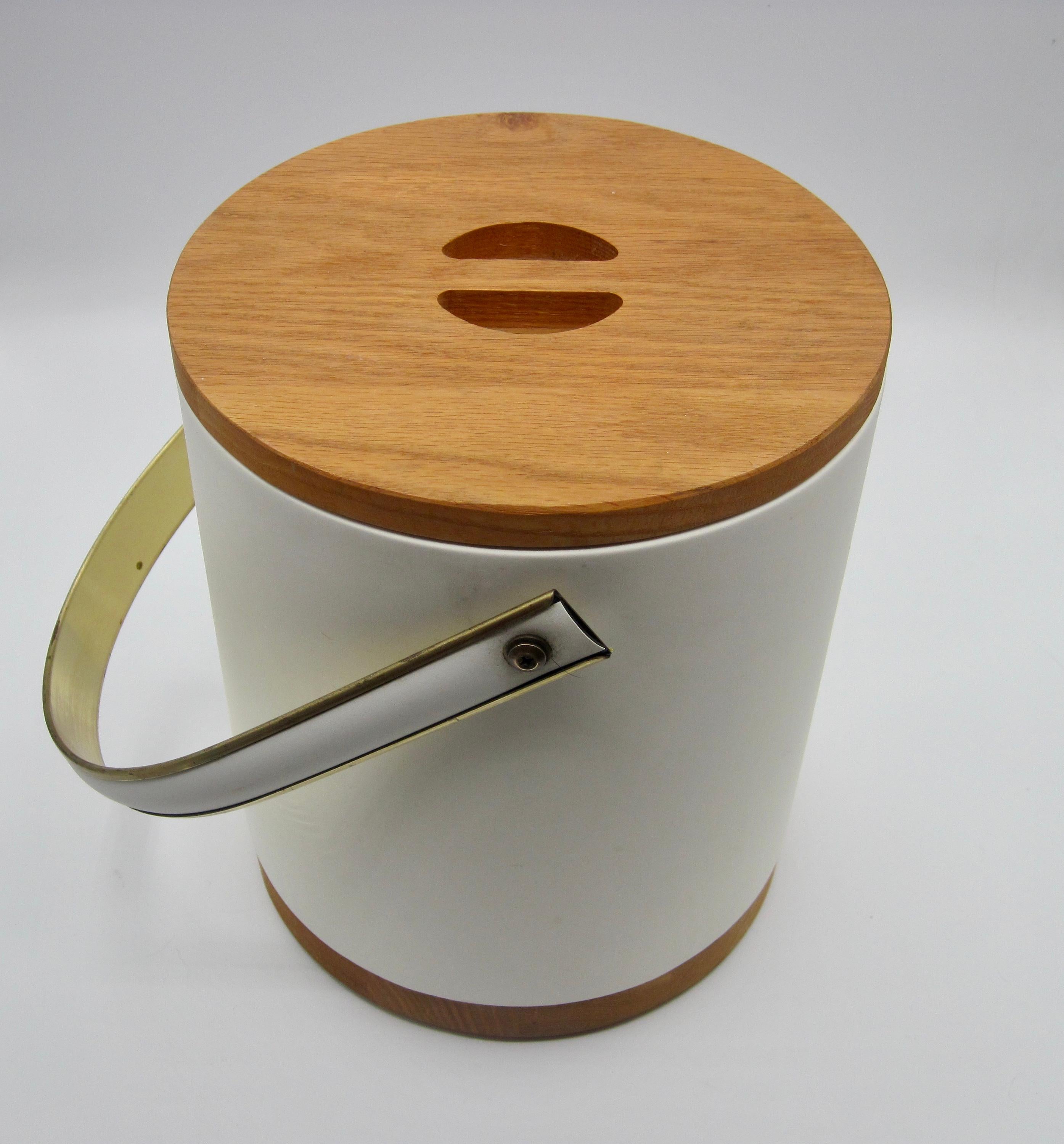 Mid-Century Modern white vinyl covered ice bucket with wood lid and base. From the Bucket Brigade Collection by Morgan and Company. A unique ice bucket in ready to use condition. Please see photos, circa 1960s-1970s.