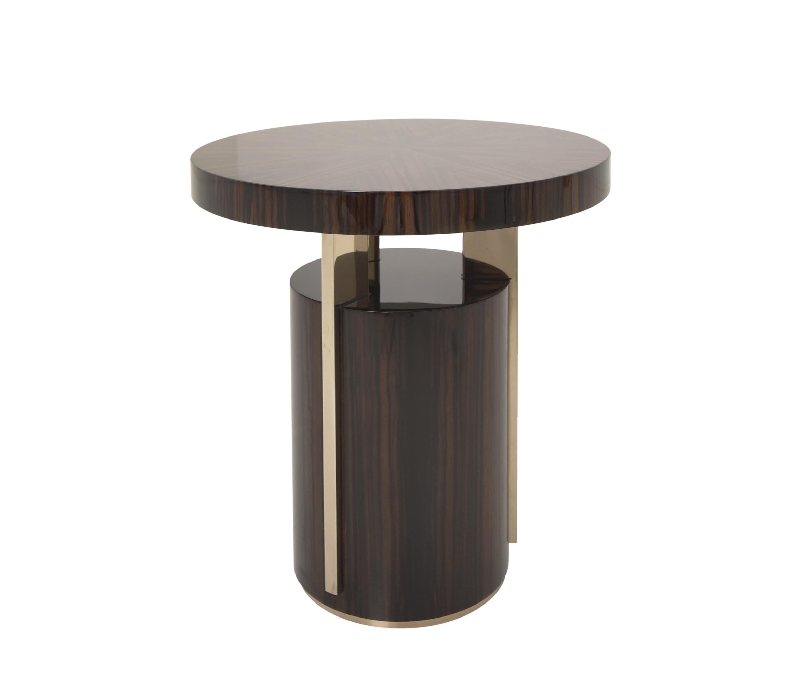 A study in balance and material contrast, this side table combines the warmth of louro preto wood finish with the subtle elegance of smoke brass. Its design is defined by three metal details in a smoke brass finish, supporting a round wooden