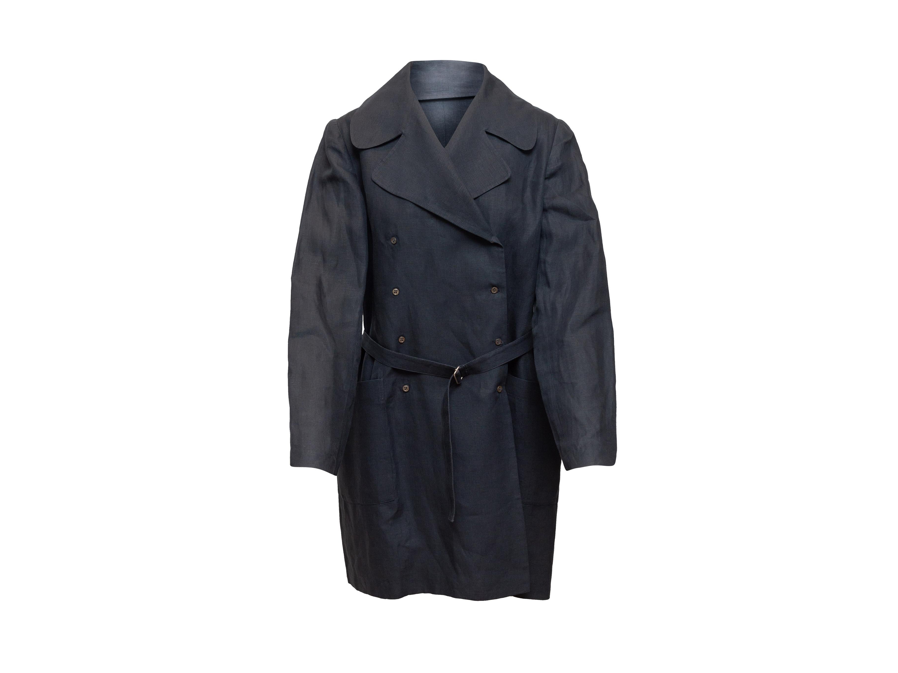 Product details: Navy linen double-breasted coat by Morgane Le Fay. Notched lapel. Dual hip pockets. Belt at waist. Button closures at front. 36