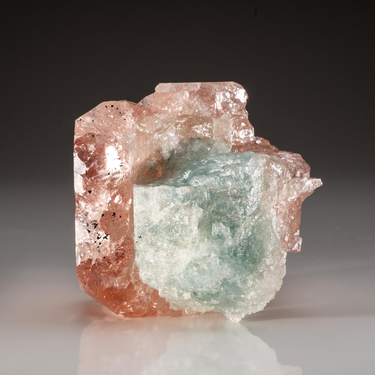 From Mawi Pegmatite, Nuristan Province, Afghanistan

Doubly-terminated pink morganite crystal with aquamarine. The front has flat basal pinacoid termination faces with secondary faces. The aquamarine crystals is highly transparent.

Weight: 1.35