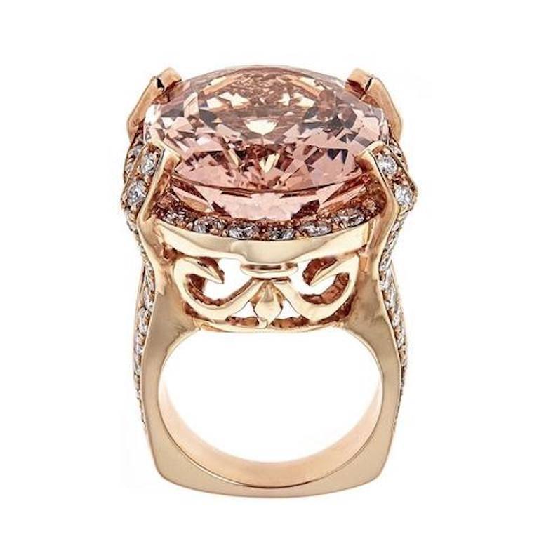 Handmade 18k rose gold ring featuring a beautiful 32 carats Morganite stone in the center accented with approximately 3.8 carats in white round diamonds.