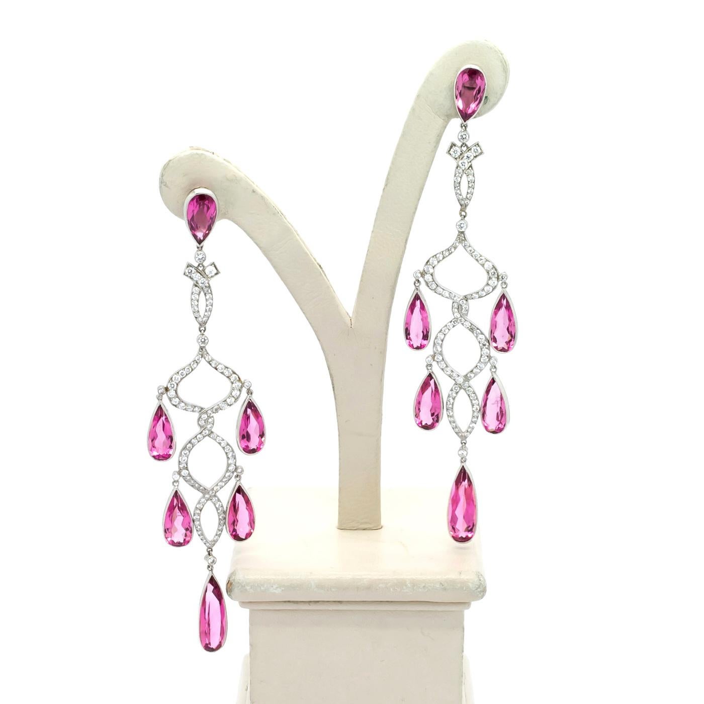 A pair of modern, morganite and diamond chandelier earrings, each earring compromising a pear-cut morganite suspending a diamond set drop in the form of two entwined ribbons and a further five pear-cut morganites, mounted in 18ct white gold,