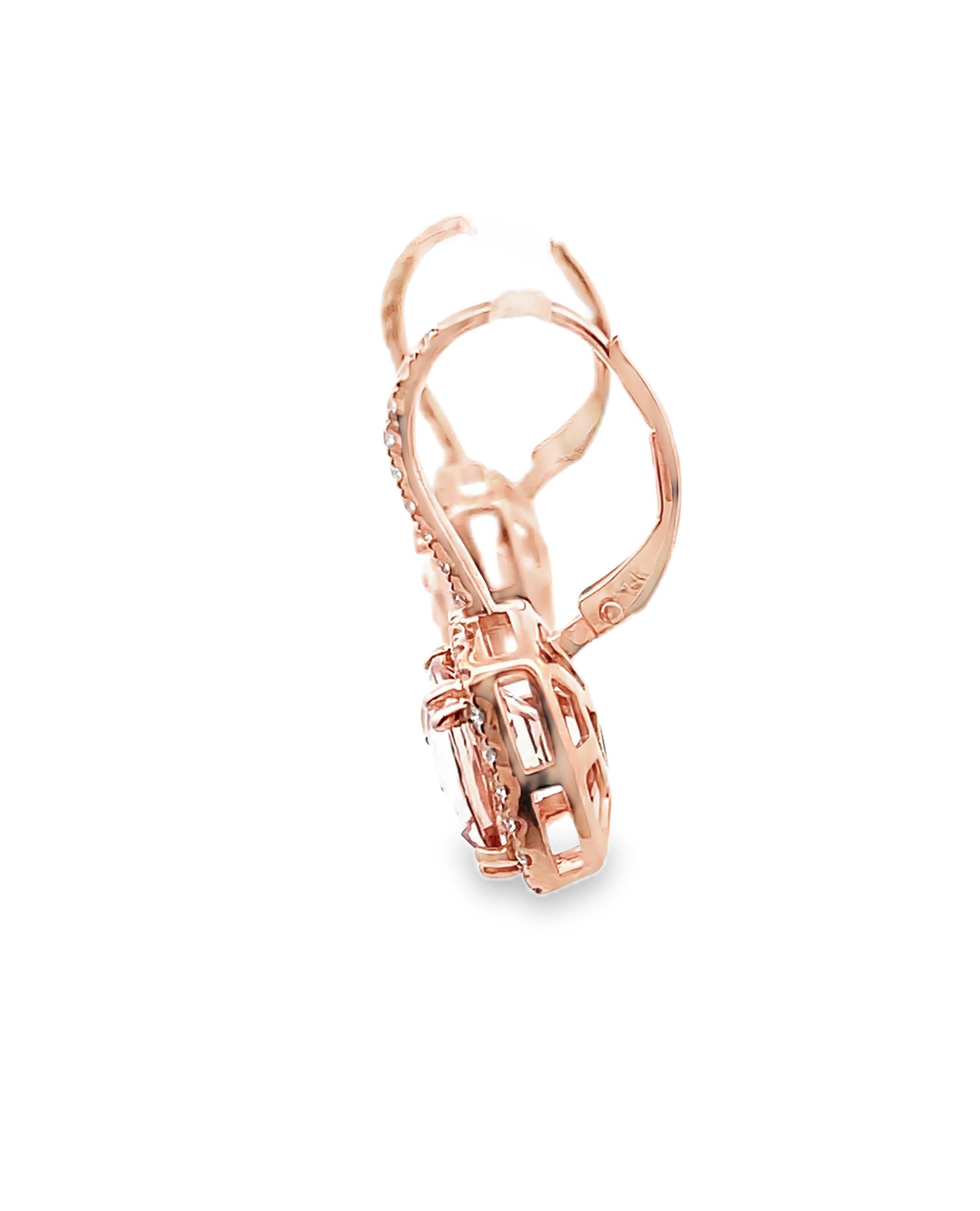 Pair of 14K rose gold drop earrings with morganite and halo diamonds.  The earrings have round brilliant-cut diamonds weighing 0.62 carat total.  In the center, two cushion shape morganites weighing 5.59 carats total. 

- Diamonds are G/H color, SI