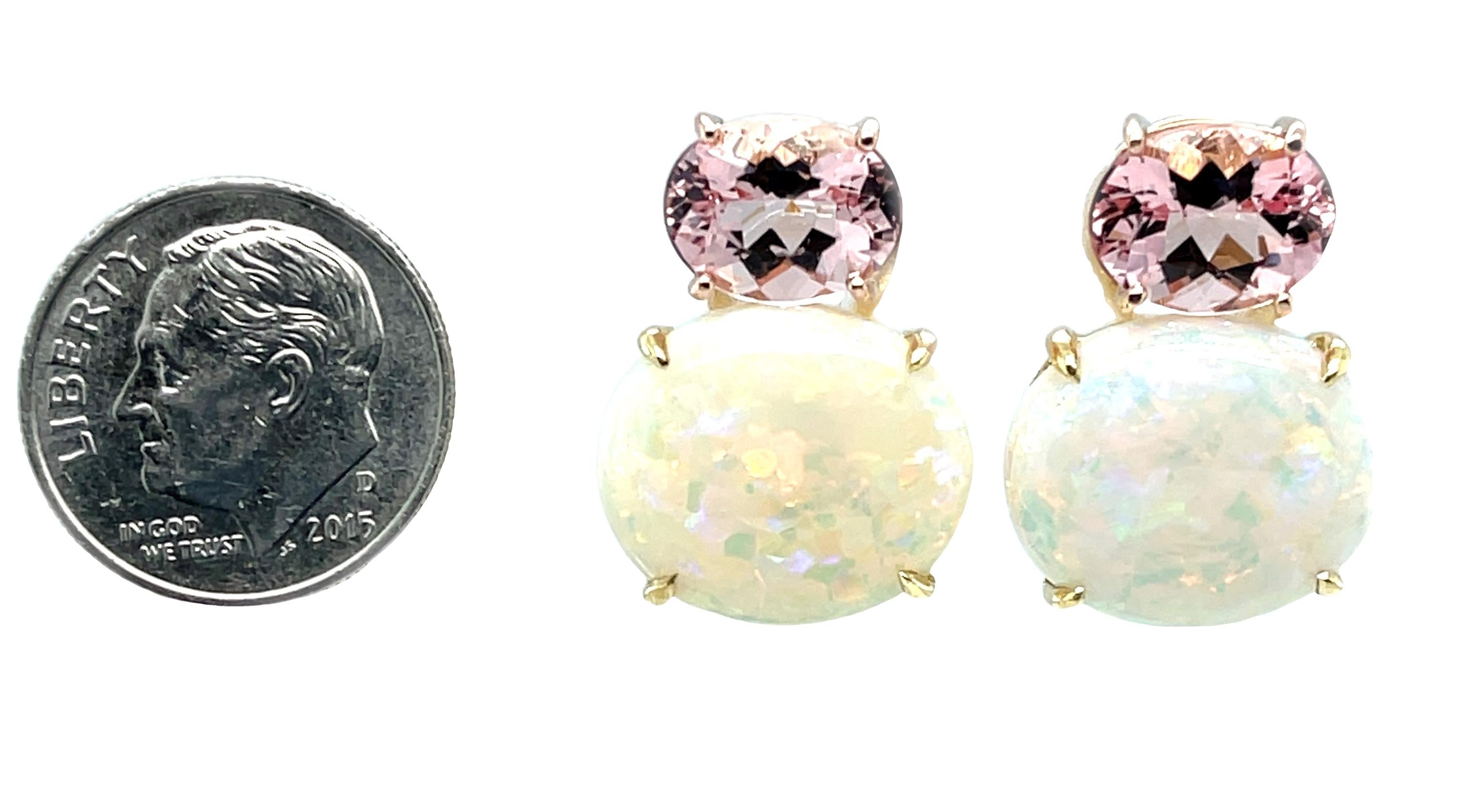 These elegant earrings feature a gorgeous pairing of cherry blossom pink morganite and colorful opals set in 18k gold! The bright pink morganite sparkle in 18k rose gold, while the opals with their rainbow of colors are highlighted in yellow gold. A