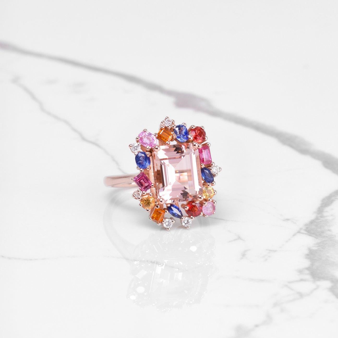 This ring is absolutely magnificent and full of beautiful colors! The main stone is a gorgeous emerald cut morganite that is 4.02 carats. Surrounding the morganite is a beautiful colorful halo of sapphires and diamonds that are cut in different