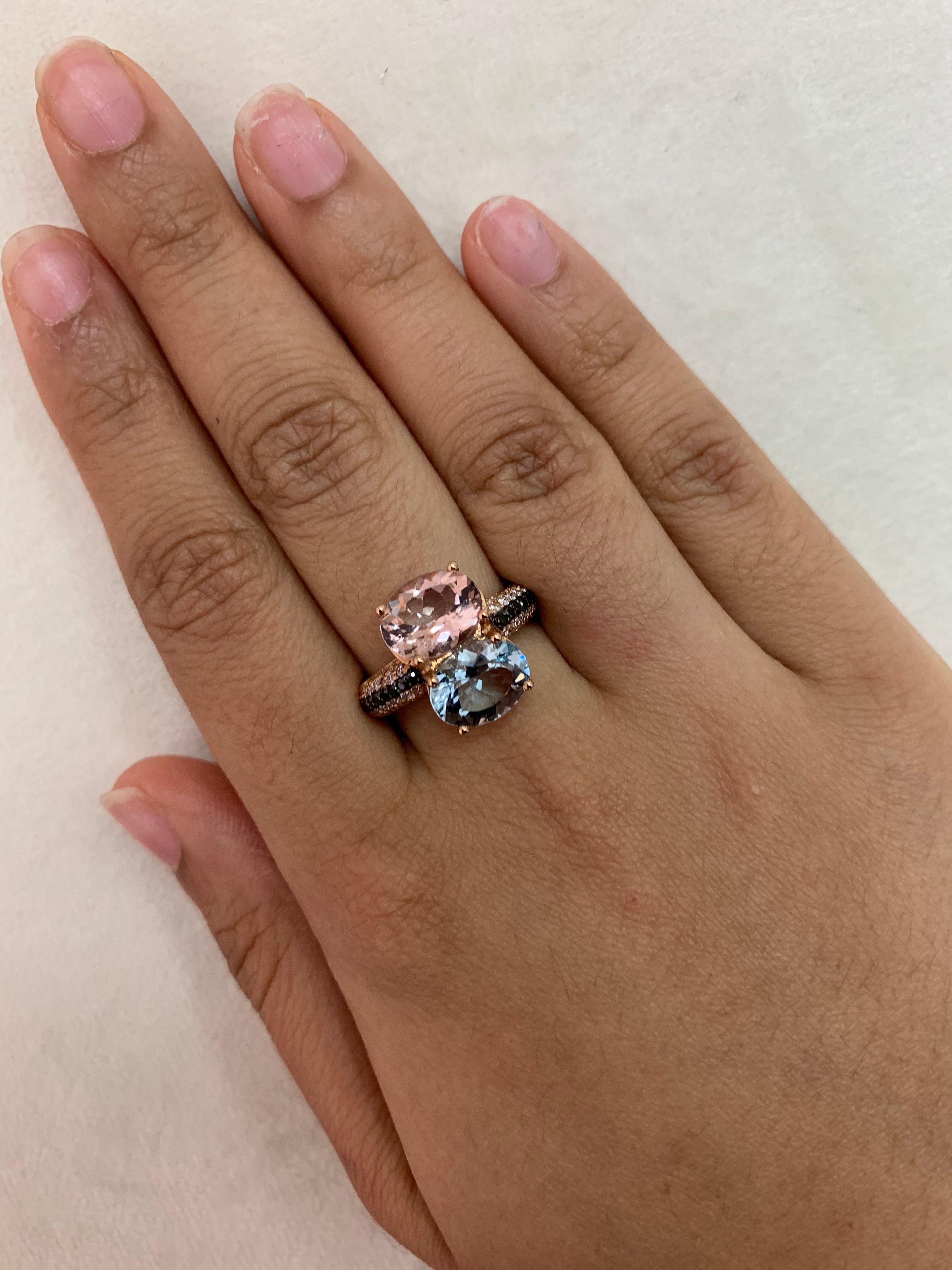 A classic summer ring featuring the warm tones of morganite and aquamarines! Accented with black and white diamonds this ring is made in rose gold and presents a classic yet elegant look. 

Classic morganite and aquamarine ring in 14K rose gold with