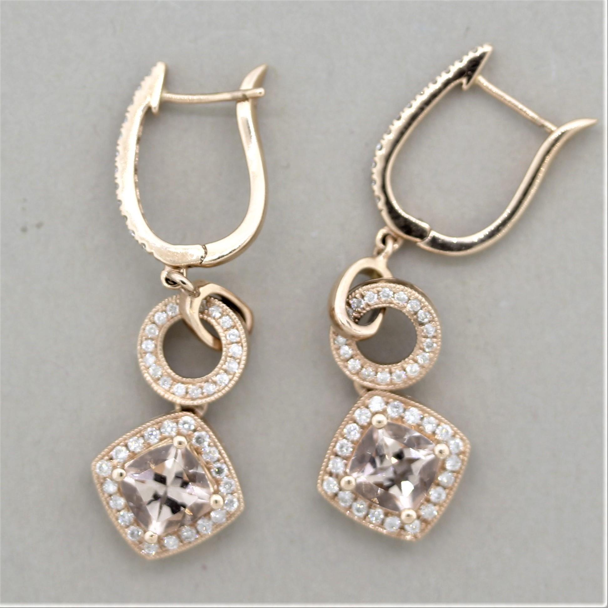 A pair of long and stylish drop morganite earrings! The cushion-shaped morganites weigh a total of 1.70 carats and have a lovely pinkish-peach color. They are accented by 0.74 carats of round brilliant-cut diamonds set around the morganites as well