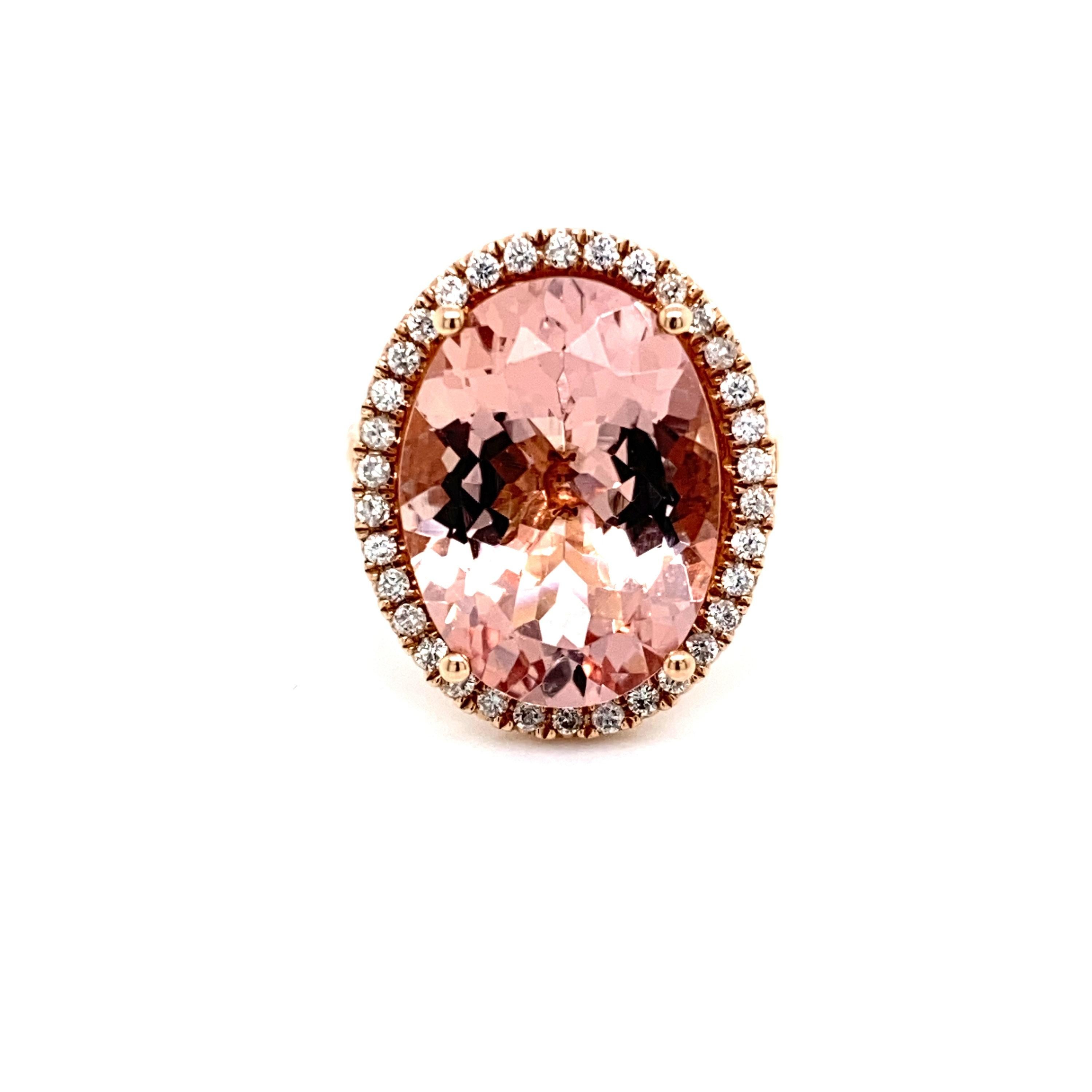 This is a magnificent natural 11.06 morganite and diamond halo ring set in solid 14K rose gold. The natural and large 18X13MM Morganite oval has an excellent peachy pink color (AAA quality gem) and is set on top of a gorgeous diamond encrusted