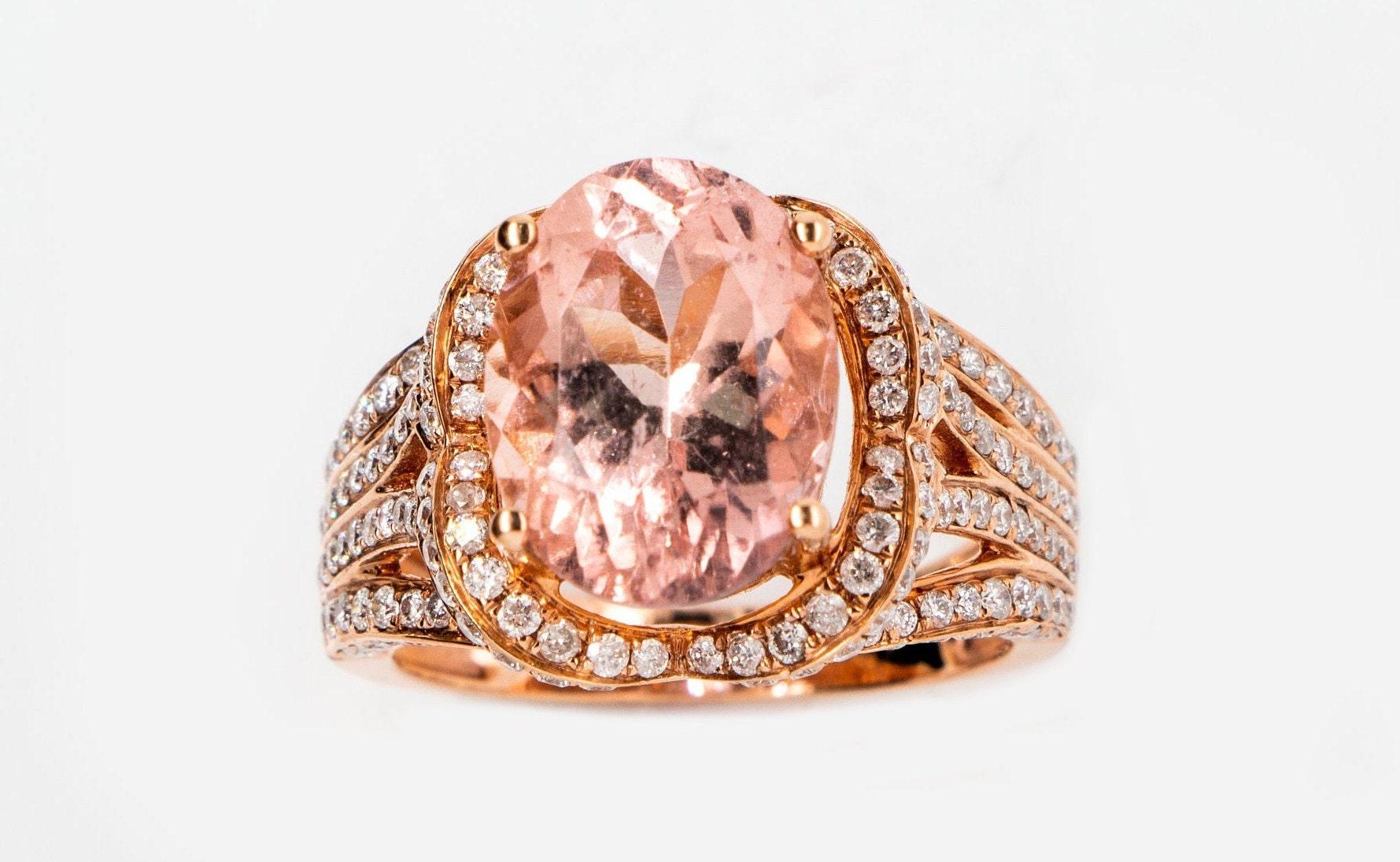 This is a magnificent natural 5.29ct morganite and diamond cocktail ring set in solid 14K rose gold. The natural and large 13X10MM Morganite oval has an excellent peachy pink color (AAA quality gem) and is set on top of a gorgeous diamond-encrusted