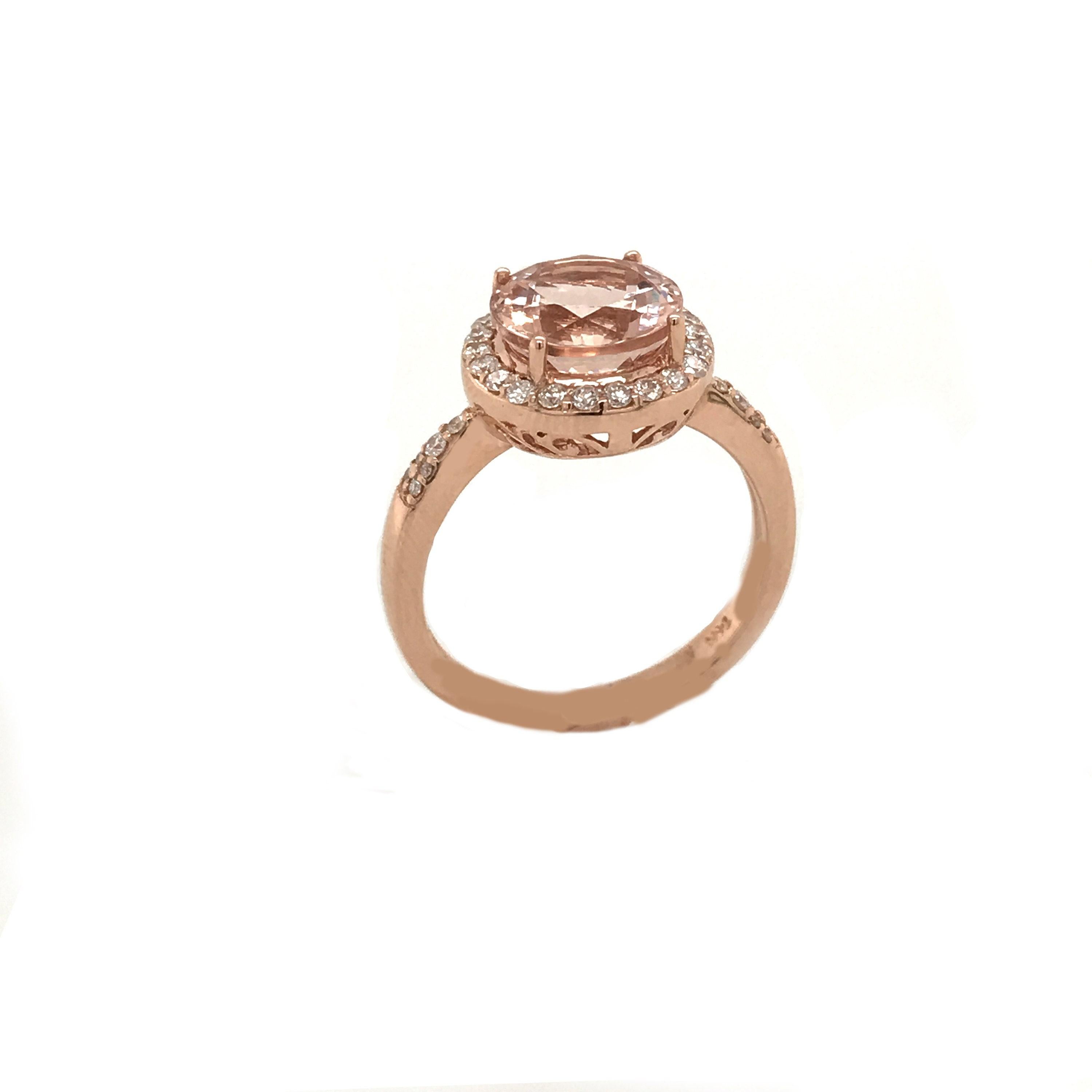 This is a magnificent natural morganite and diamond cocktail ring set in solid 14K rose gold. The natural and large 12X10MM 3.61CT Morganite oval has an excellent peachy pink color (AAA quality gem) and is surrounded by a double diamond halo set on