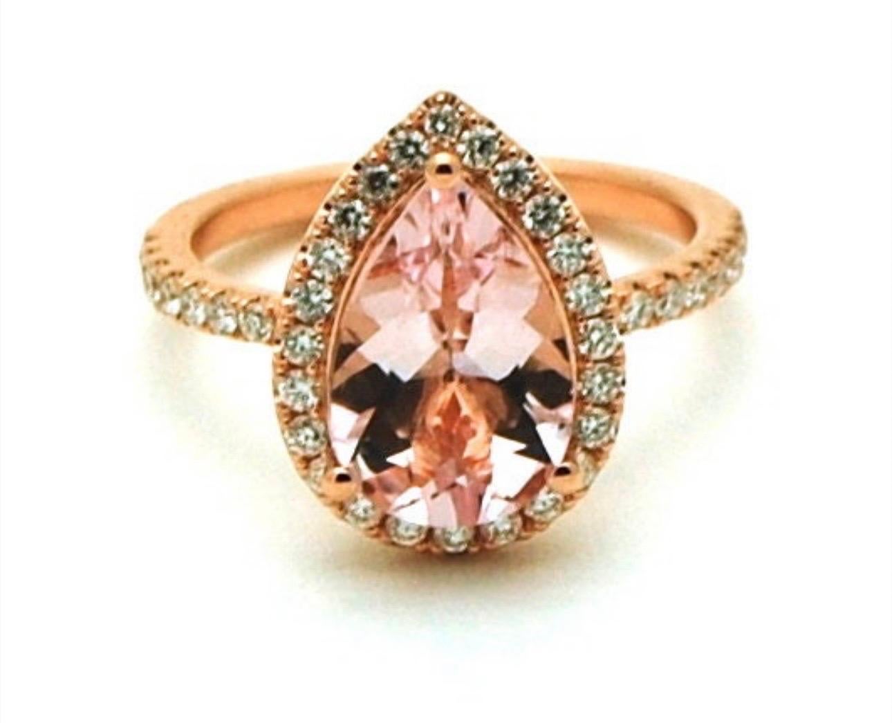 Canadian diamonds paired with a peachy morganite in 18KT gold. Such a lovely combination, such a warm ring made with top diamonds at VS clarity and E-F color. Ring is size 7 but can be re-sized easily. Morganite is 10x7mm pear cut, peachy pink color