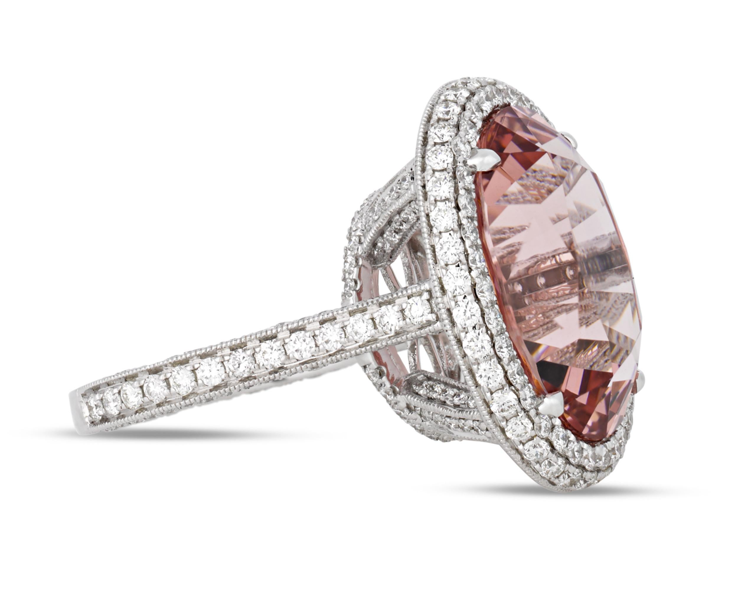 This stunningly romantic ring features a peachy morganite weighing 12.74 carats encircled by a halo of white diamonds totaling 1.69 carats. After morganite's discovery in Madagascar in 1910, Tiffany & Co. introduced this gem to the American market,