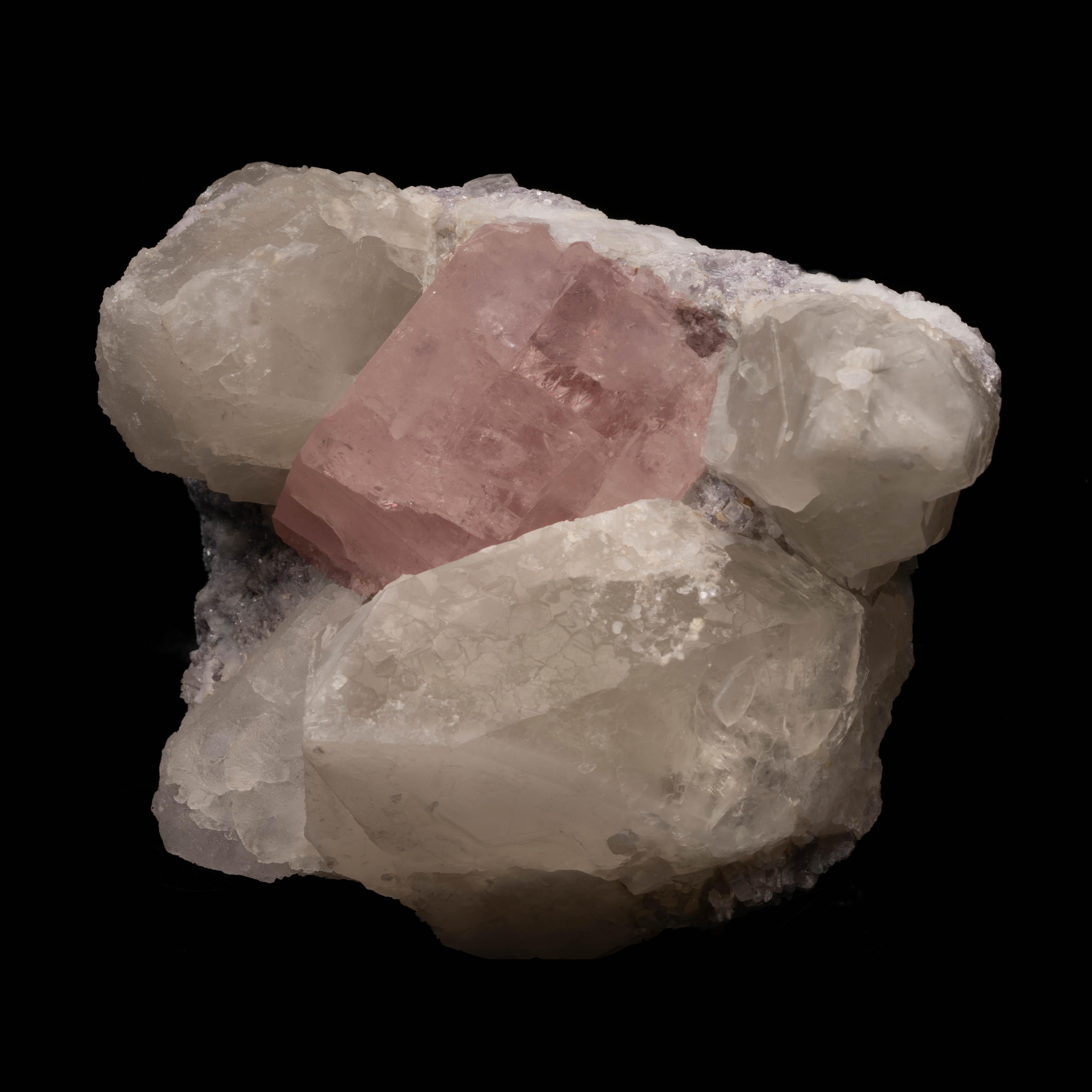 This truly special combination specimen from the Paprok Mine, Kamdesh District, Nuristan Province, Afghanistan features a large beautifully formed and gemmy pink morganite crystal framed by hefty naturally terminated smoky quartz points all on a bed