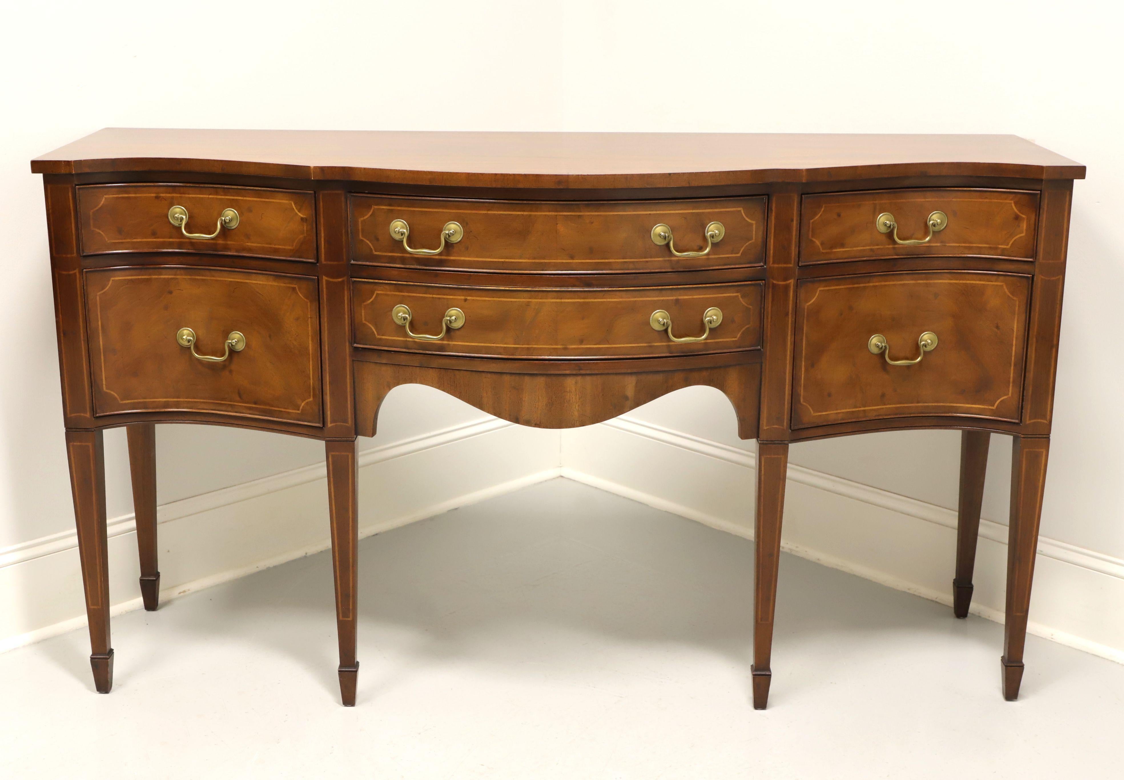 A vintage Hepplewhite style sideboard by Morganton Furniture, from their Tidewater Collection. Mahogany with string inlay to drawer fronts & legs, serpentine front, brass hardware, tapered straight legs and spade feet. Features two larger center
