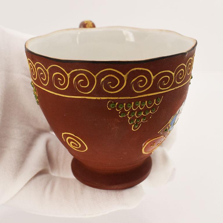 20th Century Moriage Figural Porcelain Teacup and Saucer in in Maroon and Gold, Japan For Sale